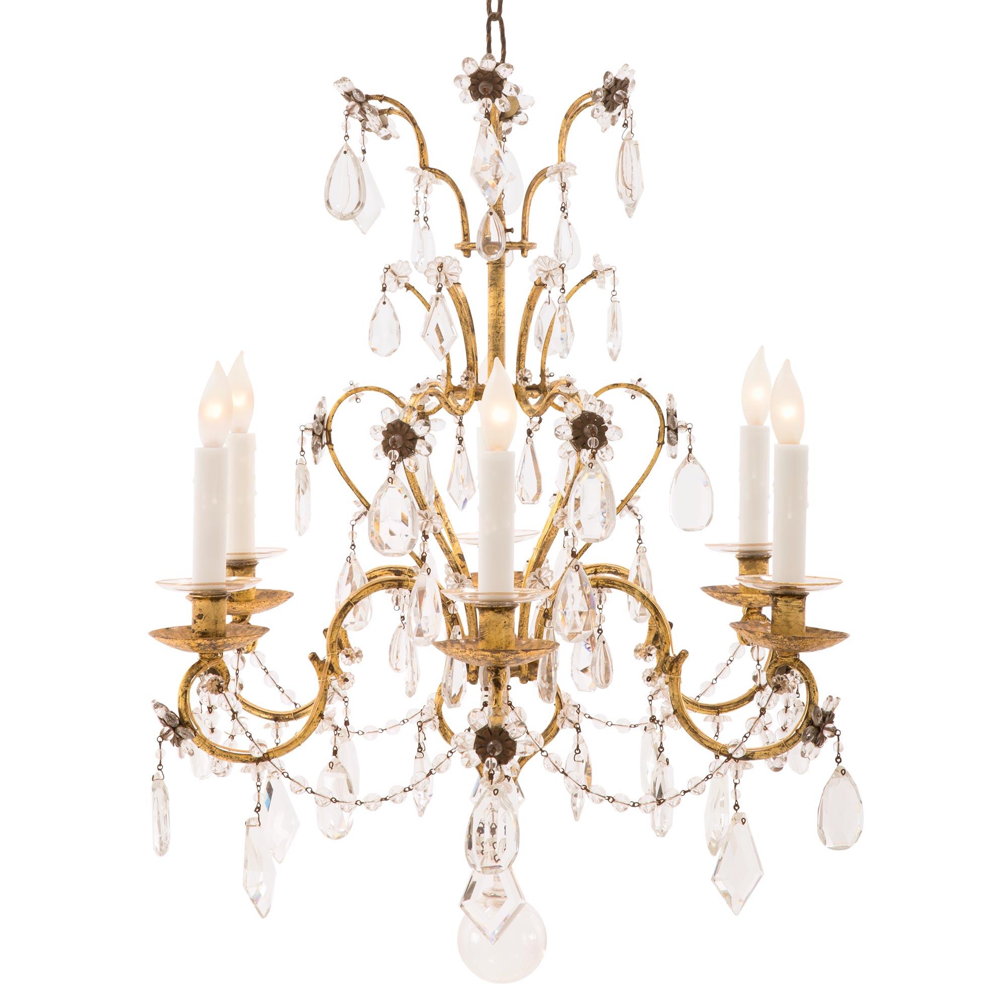 A beautiful and most decorative Italian 19th century Louis XV st. gilt metal, crystal, and cut glass chandelier. The six arm chandelier is centered by a lovely hand blown glass ball pendant below the beautifully scrolled gilt metal cage. The