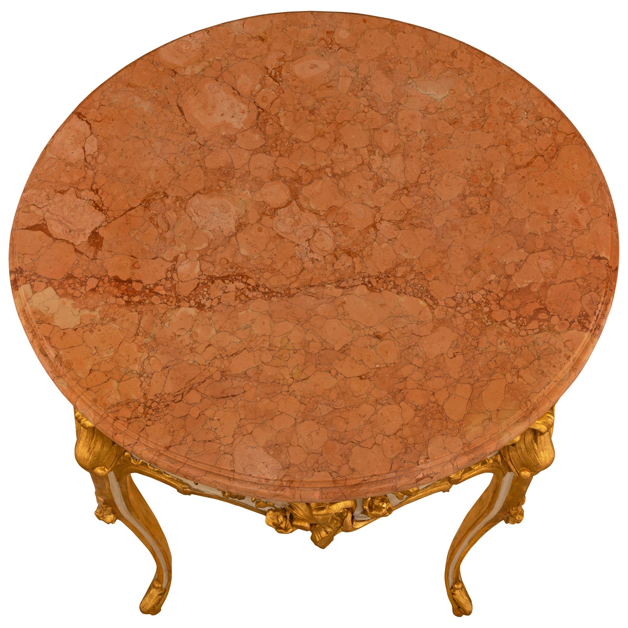 A beautiful and high quality Italian 19th century Louis XV st. patinated wood, Giltwood and Giallo Antico marble side/center table. The circular side table is raised by most elegant 'S' scrolled cabriole legs and supported by feet with an acanthus
