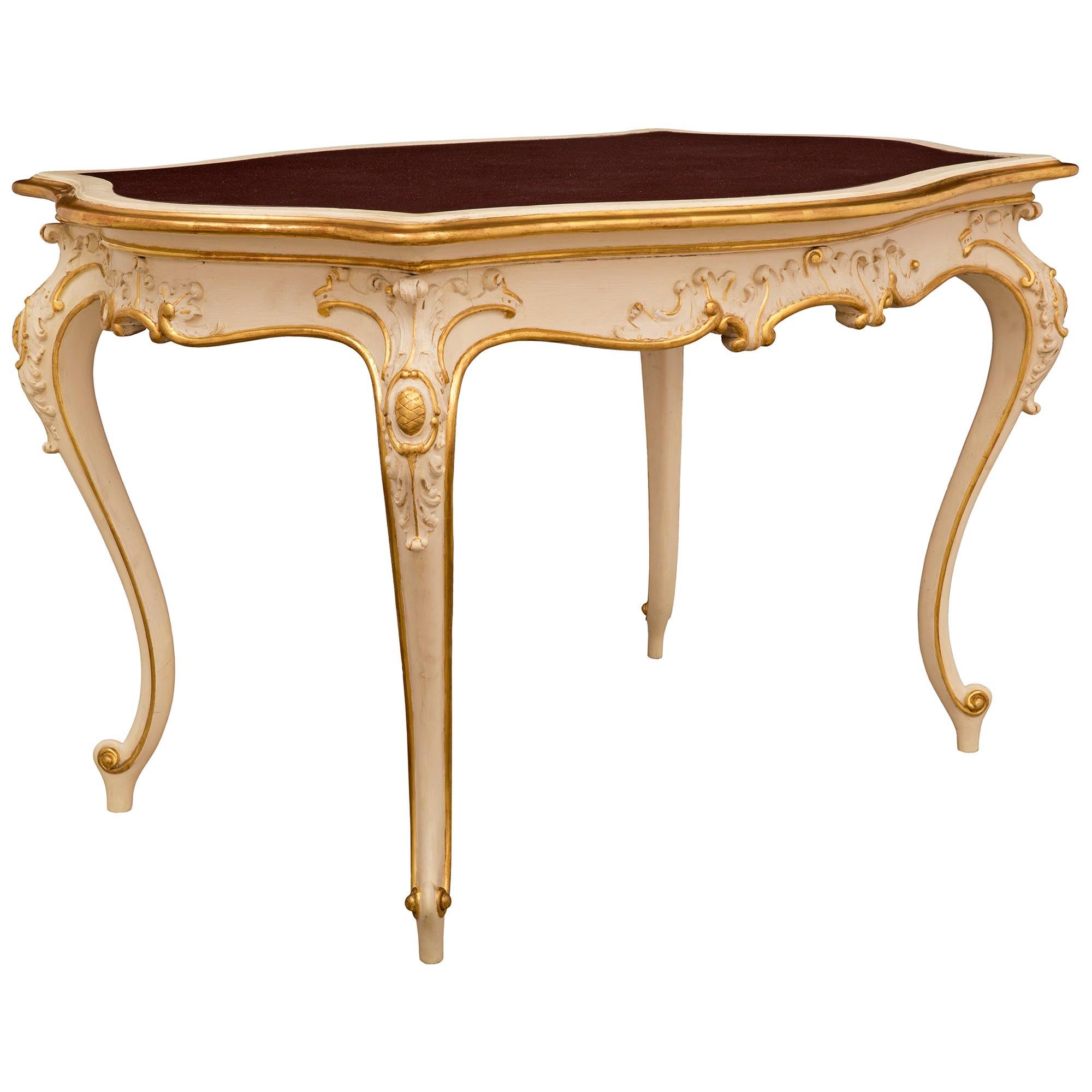 A beautiful and most elegant Italian 19th century Louis XV st. patinated, giltwood, and faux painted porphyry center table. The oblong scalloped shape table is raised by fine slender cabriole legs and topie shaped feet with lovely scrolled designs.