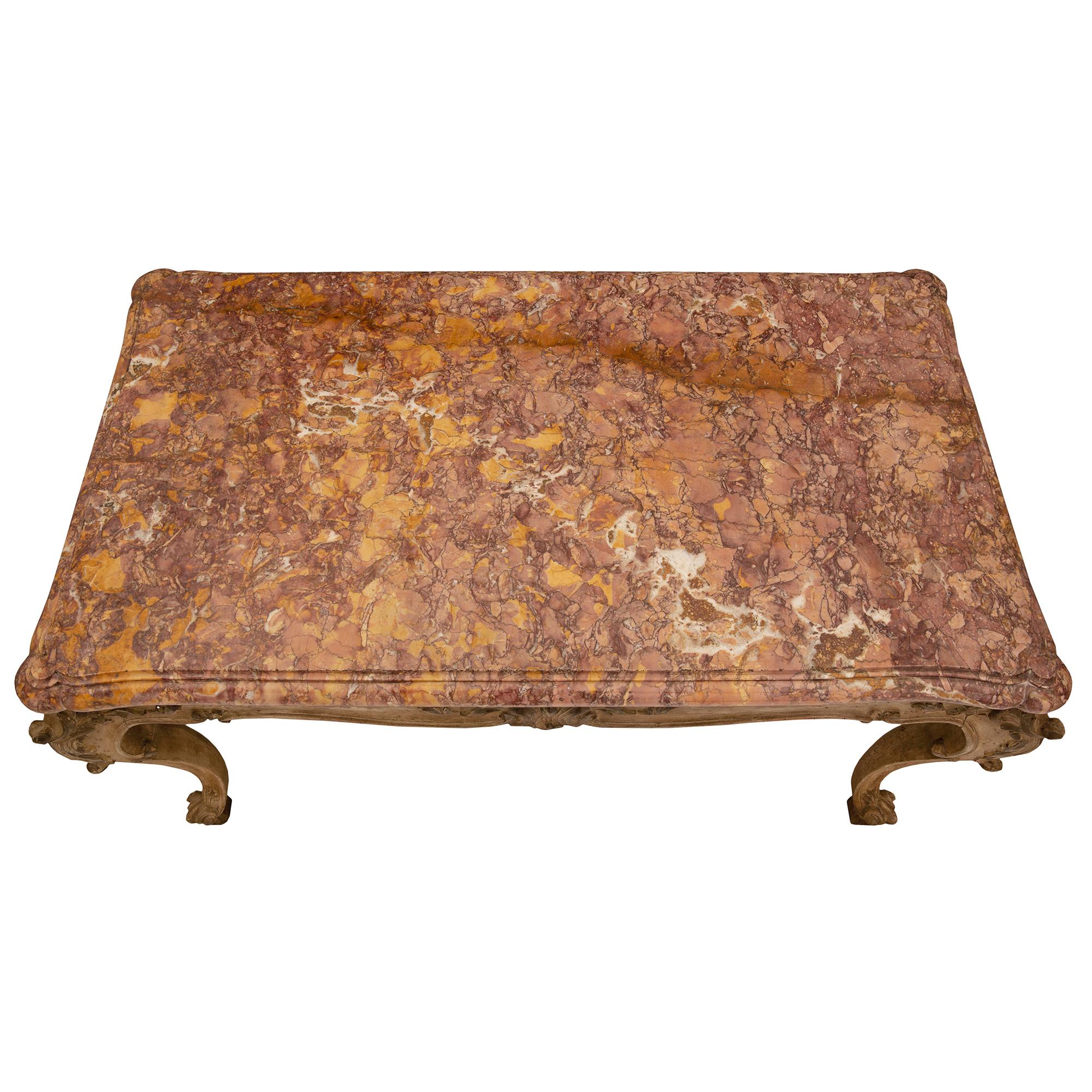 A charming Italian 19th century Louis XV st. patinated wood and Brocatelle d’Espagne marble coffee table. The coffee table is raised by elegant scrolled block feet below lovely tapered cabriole legs. A most decorative fillet extends up each leg and