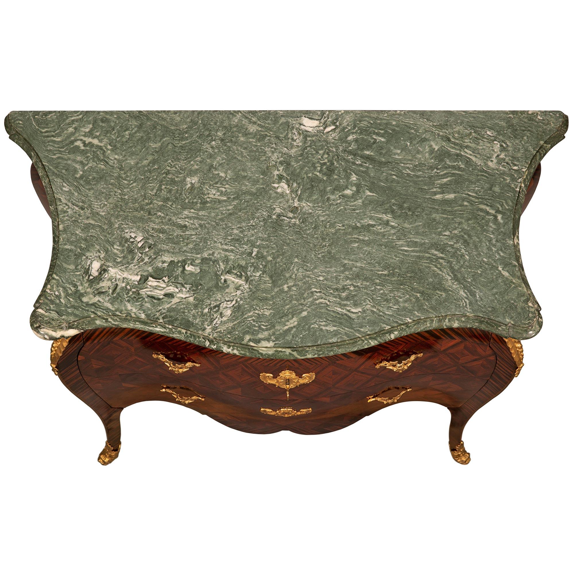 A stunning and most unique Italian 19th century Louis XV st. Rosewood, ormolu and Vert Turquin marble Roman commode. The three drawer chest is raised by elegant cabriole legs with fine fitted foliate ormolu sabots. At the center are two sans