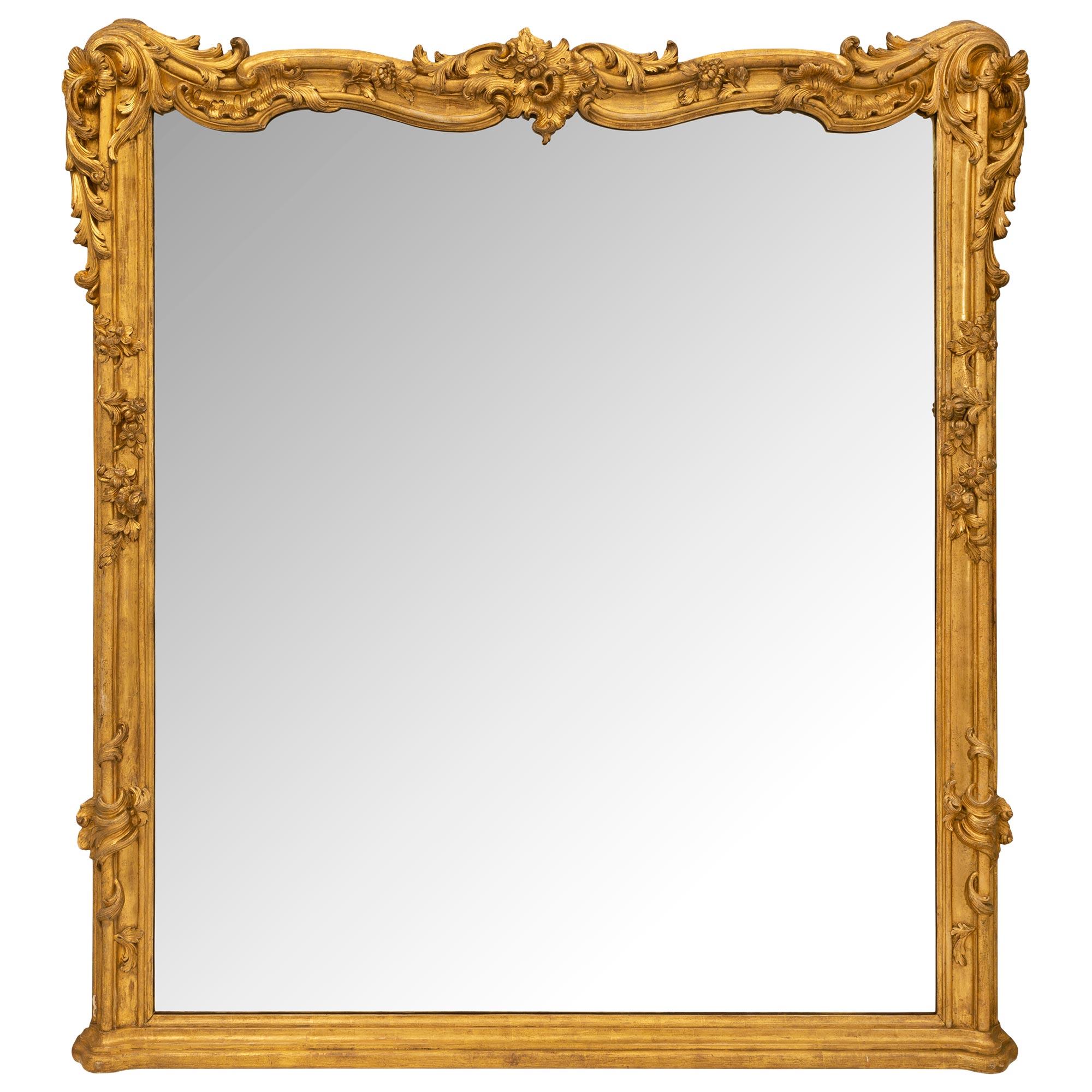 An impressive and unique Italian 19th century Louis XV st. finely carved mecca mirror. The original mirror plate within a mecca frame and has a mottled straight base and sides. Each side displays charming reeded foliate patterns with finely carved