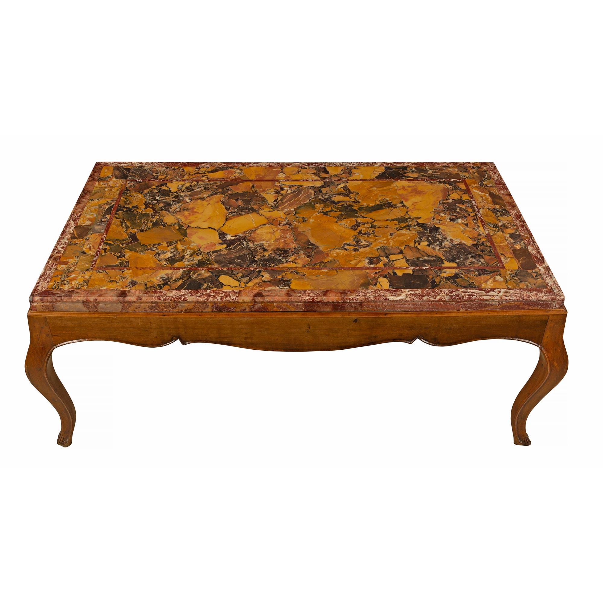 A very handsome Italian 19th century Louis XV style walnut and marble coffee table. The table is raised by Fine cabriole legs with an elegant carved border along the scalloped shaped apron. Above is the beautiful original thick Brèche marble fitted