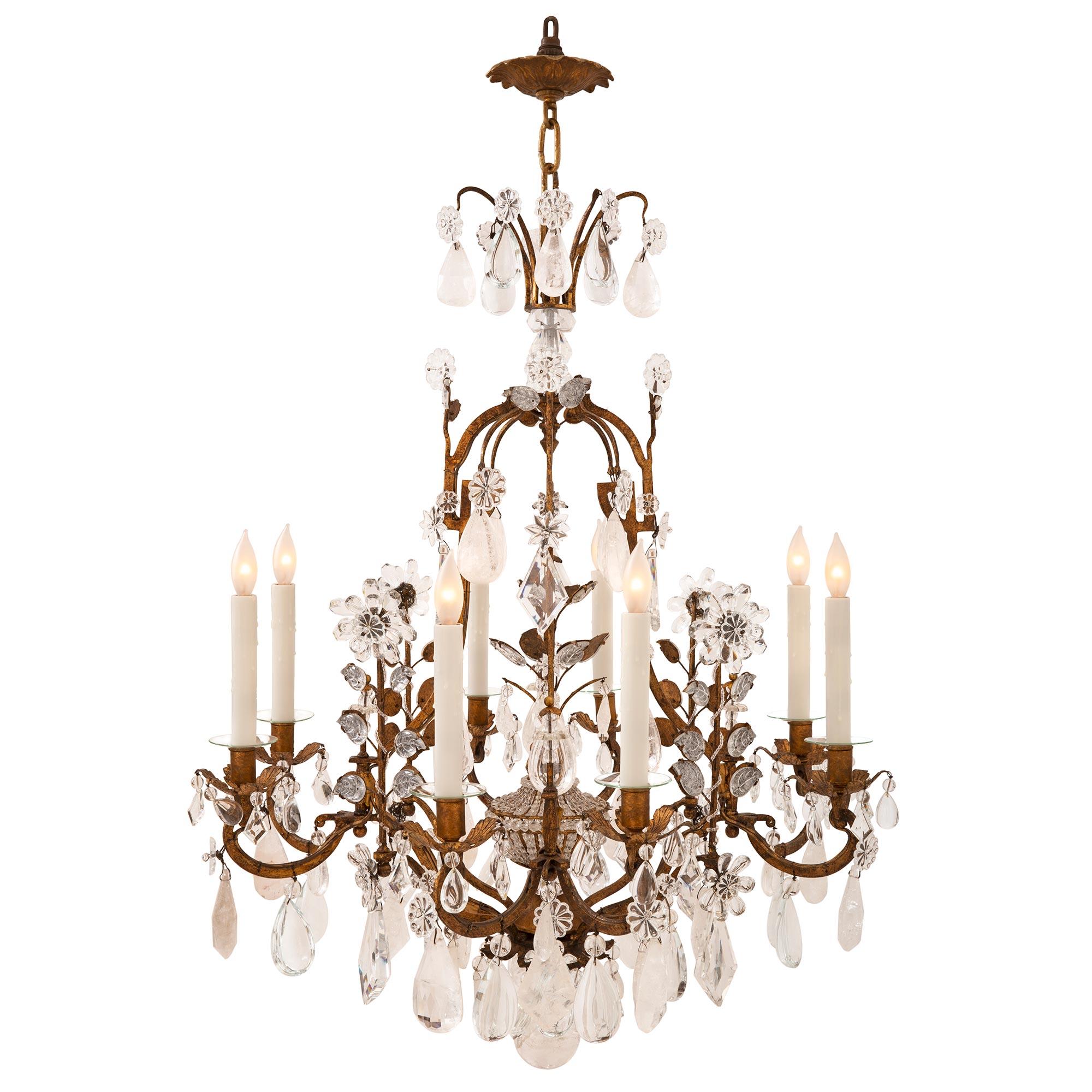 A charming and most decorative Italian 19th century Louis XVI St. gilt metal and rock crystal chandelier. The beautiful eight-light chandeliers are centered by a striking solid bottom rock crystal ball below an impressive array of cut rock crystal