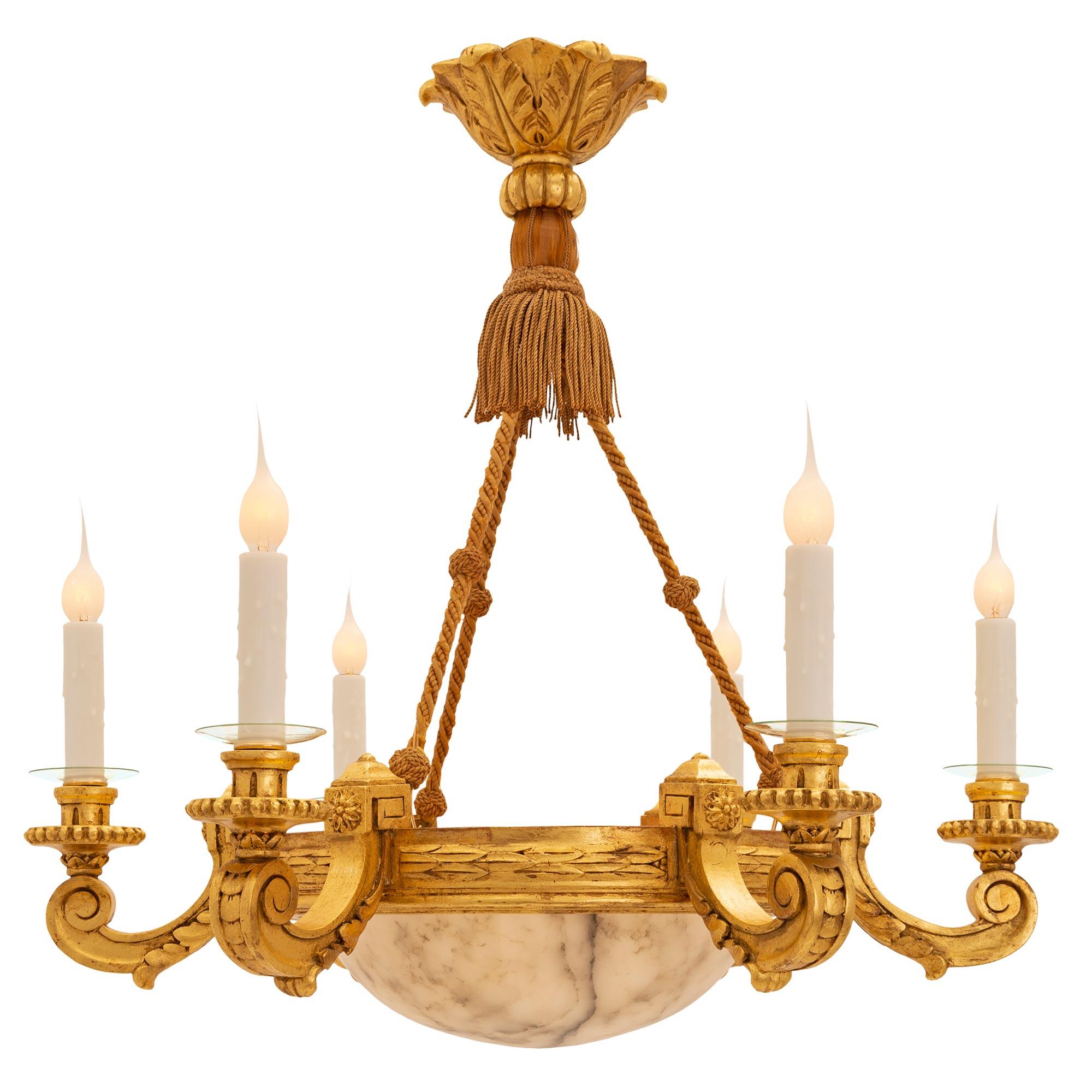 A striking Italian 19th century Louis XVI st. giltwood and Alabaster chandelier. The six-arm chandelier is centered by an exceptional and most decorative bottom Alabaster dome showcasing the beautiful veins. Each of the elegantly curved arms