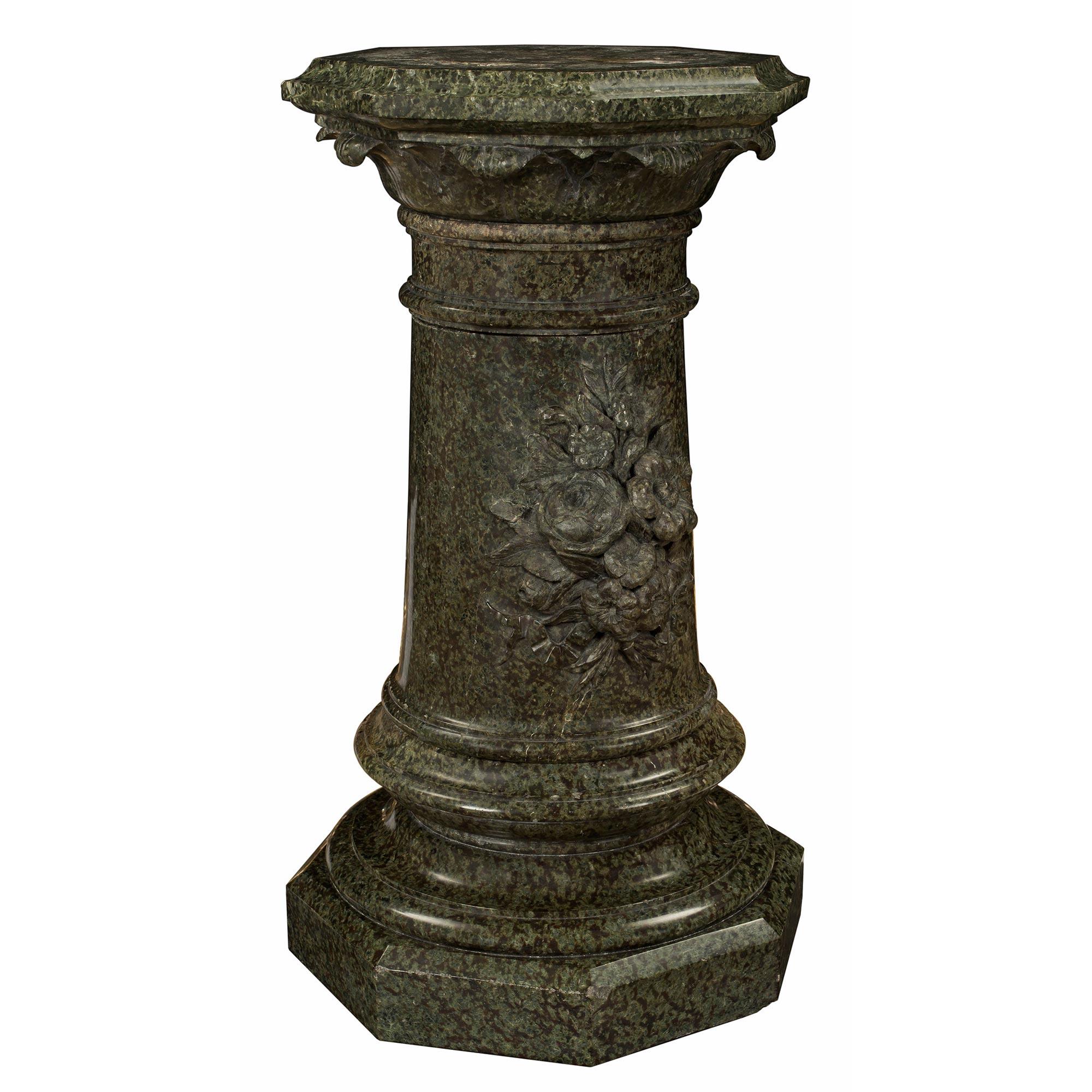 A striking Italian 19th century Louis XVI st. marble pedestal column. The most decorative pedestal is raised by an octagonal base below a circular mottled border. The circular central support displays beautiful and richly carved flowers at the front