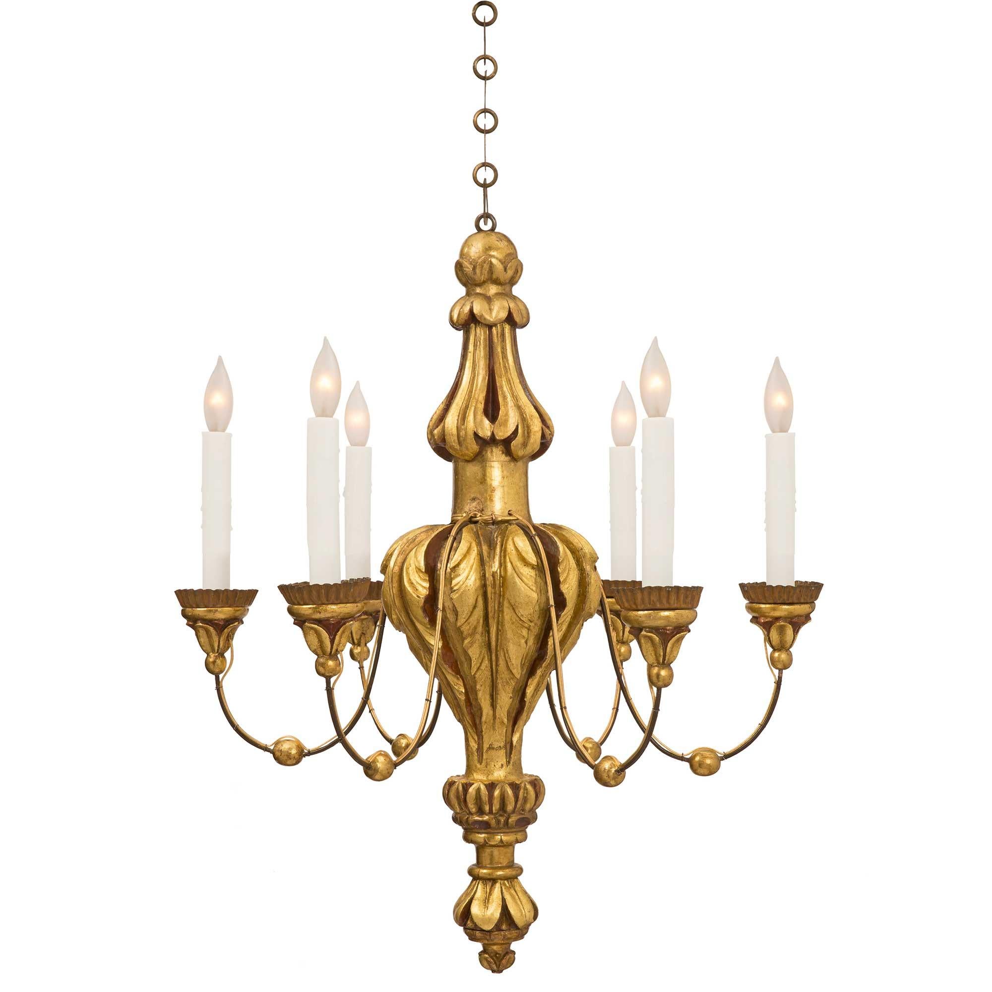 Bellissimo lampadario a sei bracci in stile Luigi XVI, policromo e in metallo stampato. Il lampadario è centrato da un terminale a fogliame rovesciato finemente intagliato e molto decorativo. Il fut centrale mostra una bella forma a balaustro