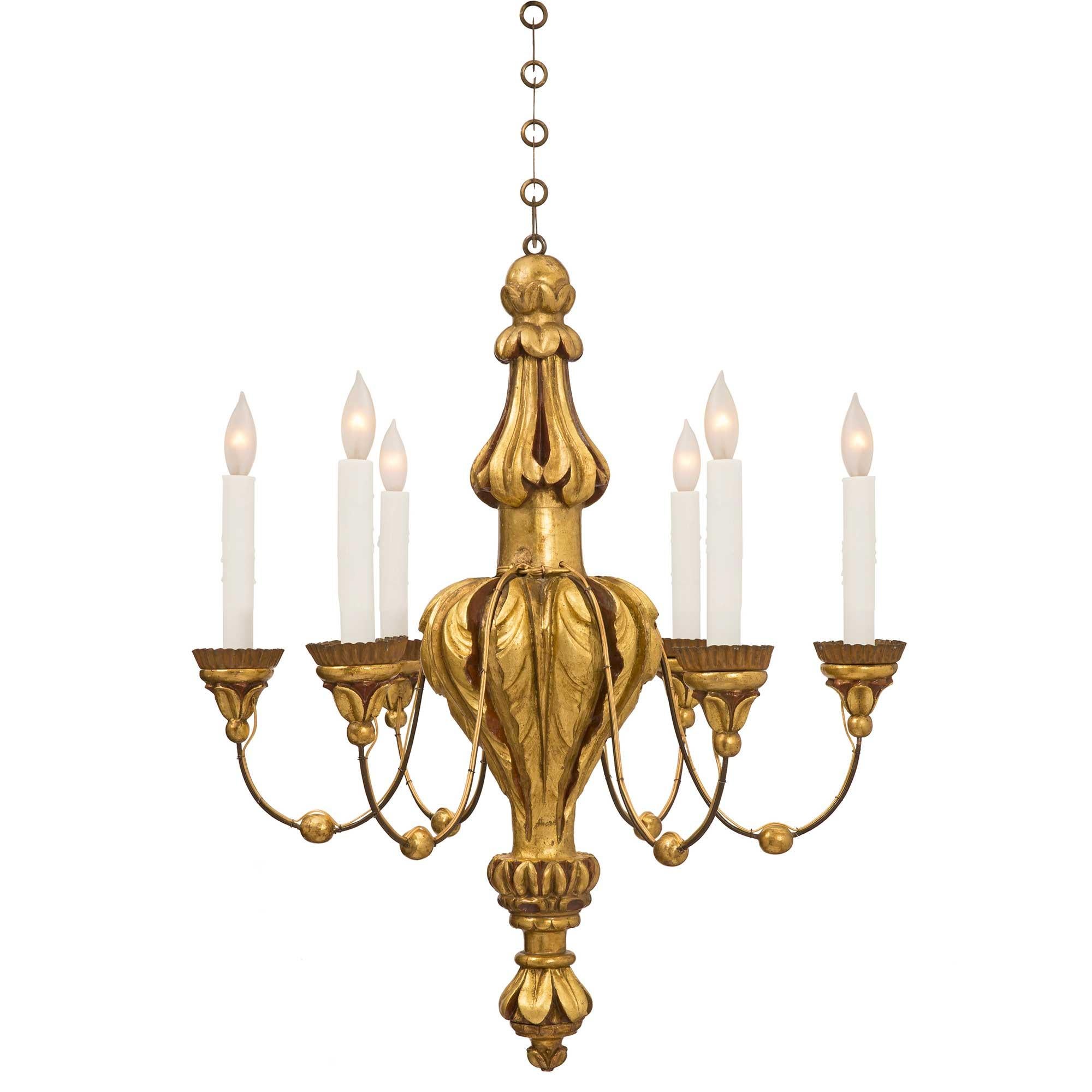 A beautiful Italian 19th century Louis XVI st. mecca, polychrome and pressed metal, six arm chandelier. The chandelier is centered by a finely carved and most decorative foliate inverted finial. The central fut displays a lovely baluster shape