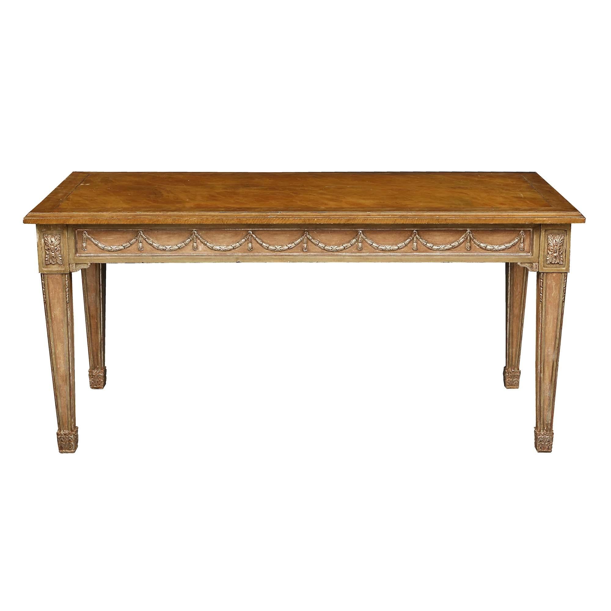 An elegant Italian 19th century Louis XVI st. patinated and Mecca center/dining table. The table is raised by handsome square tapered legs with recessed patinated panels framed in Mecca fillets and richly carved block rosettes. At the straight