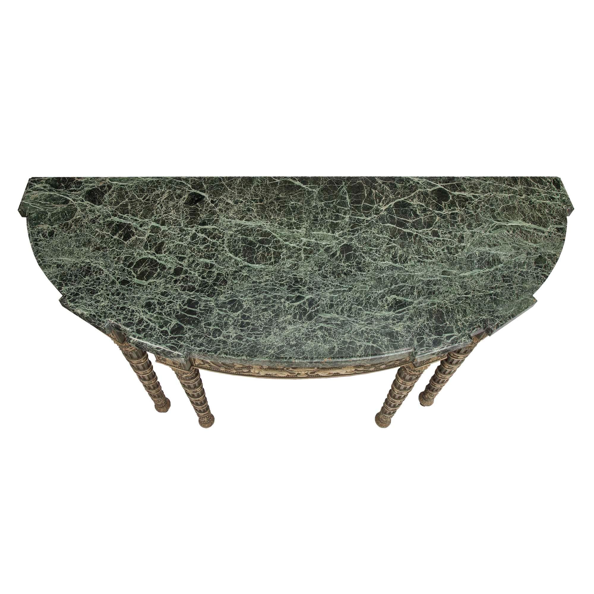A very handsome and unique Italian 19th century Louis XVI st. patinated console. The console is raised on an unusual six fluted tapered legs accented with encircling foliate garlands acanthus leaves, draped garlands and lattice designs. The curved