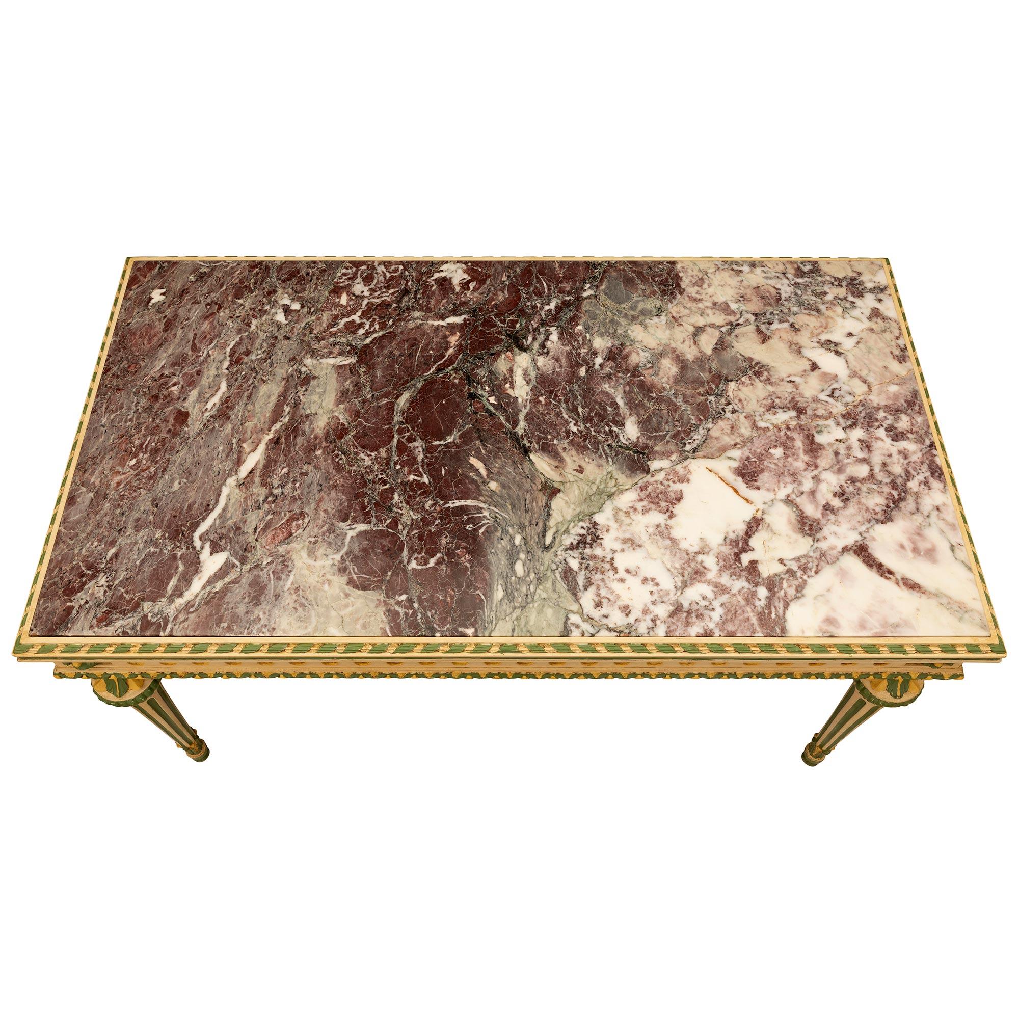 A beautiful and very unique Italian 19th century Louis XVI st. patinated wood and Brèche Violette marble center table. The rectangular table is raised by elegant circular tapered fluted legs with fine topie shaped feet with lovely acanthus leaf