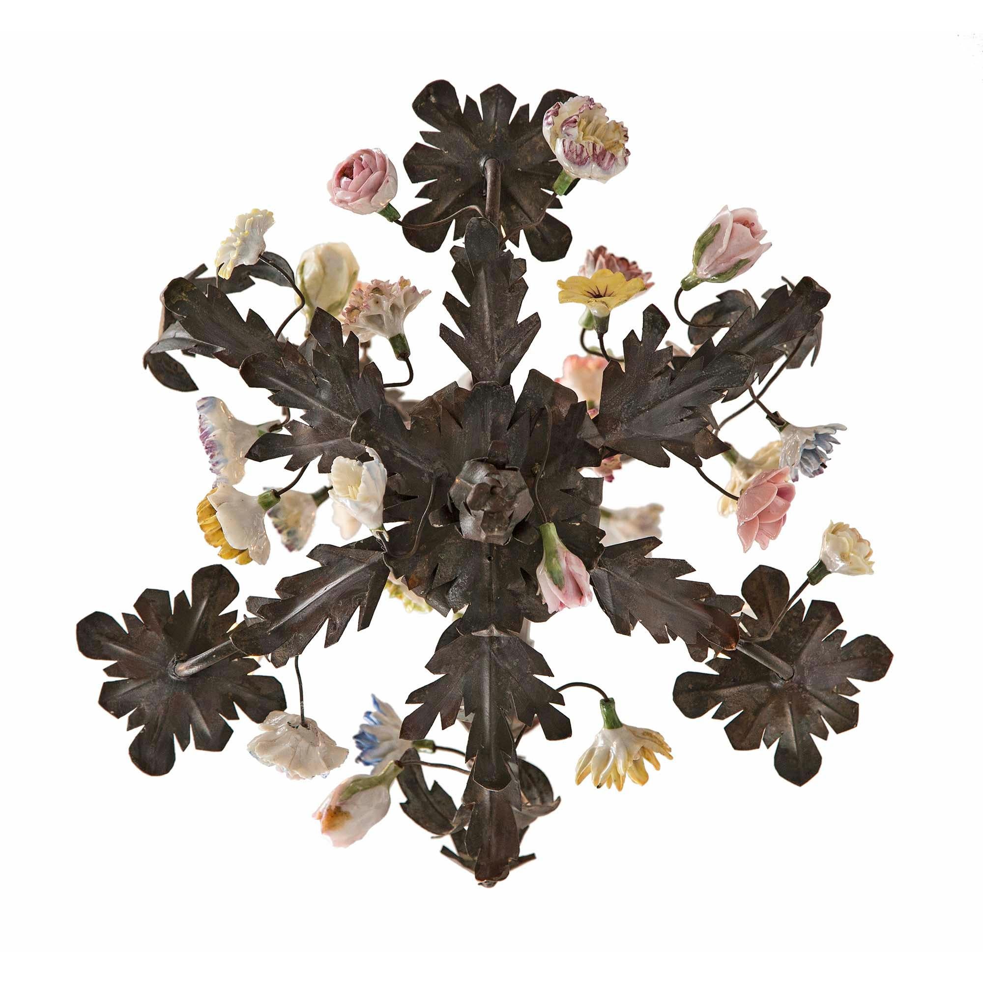 A beautiful and small scale Italian 19th century Louis XVI st. tole and Saxe porcelain three light chandelier. The chandelier is centered by a charming bottom foliate finial amidst extremely well executed and striking colored Saxe porcelain flowers