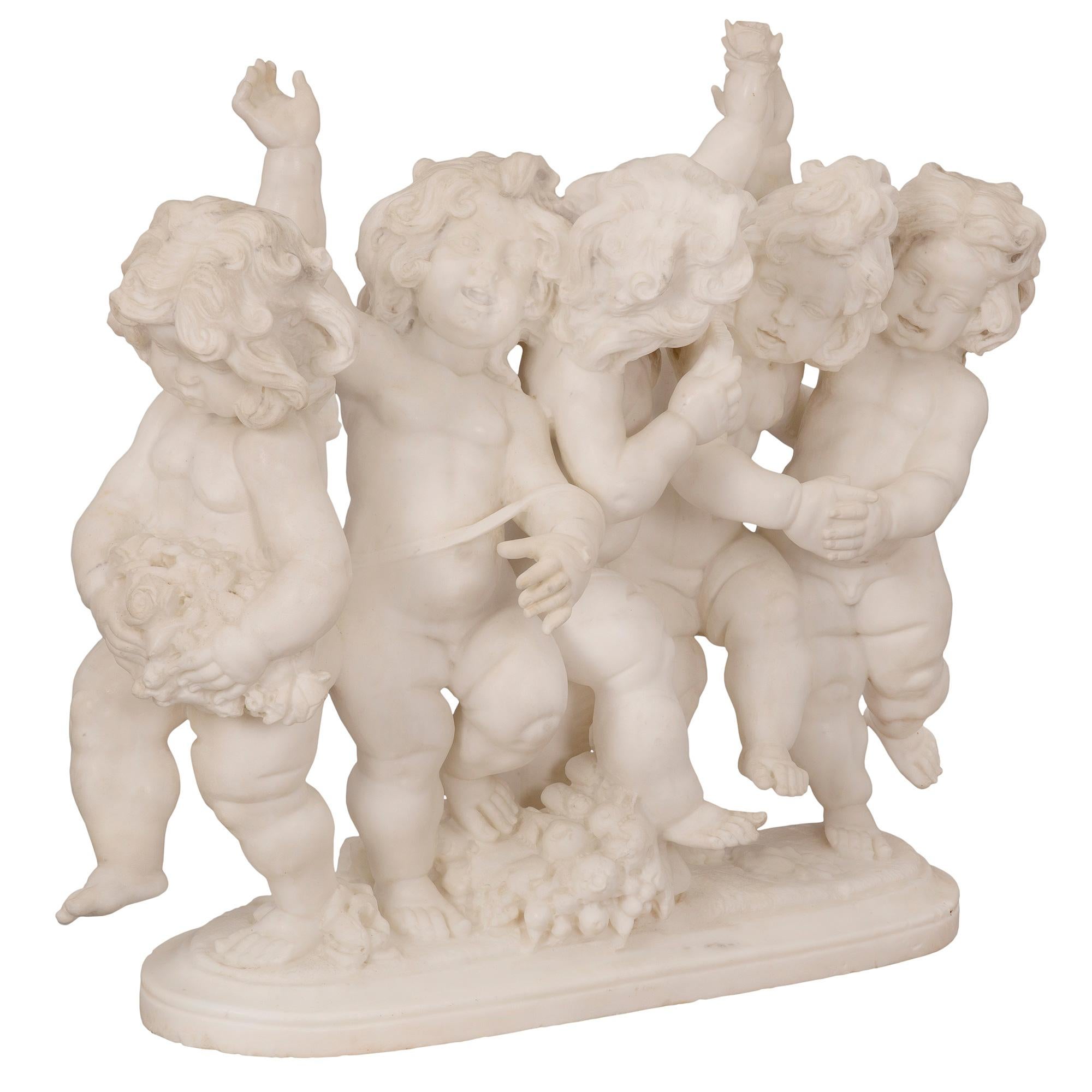 A sensational and high-quality Italian 19th century Louis XVI st. white Carrara marble statue. The statue is raised by an oblong base with a fine wrap around mottled border. Above are five most charming and richly sculpted cherubs who are joyfully