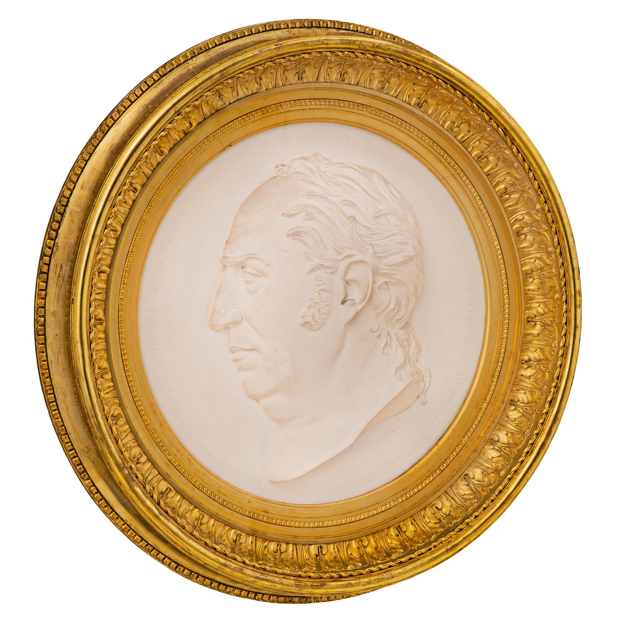A most impressive and extremely well executed Italian 19th century Louis XVI st. giltwood and plaster wall plaque, signed P. GRASS 1864. The exceptionally carved wall decor is centered by a handsome and finely detailed man with the