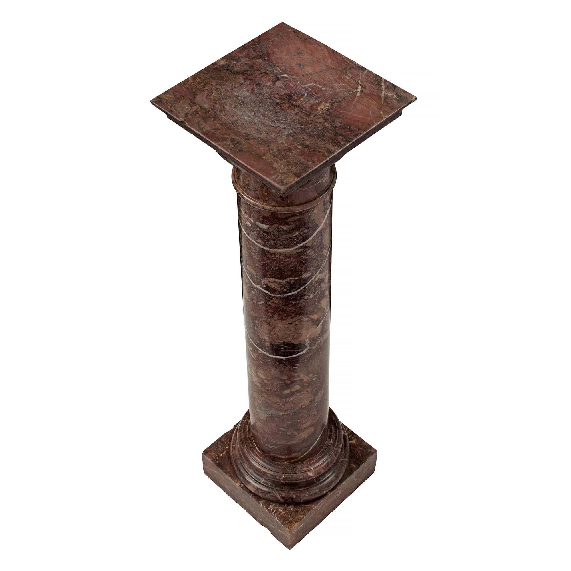 A beautiful Italian 19th century marble pedestal. The pedestal is raised by a square base with a circular mottled design and round column. Above the mottled design is the square display surface.

