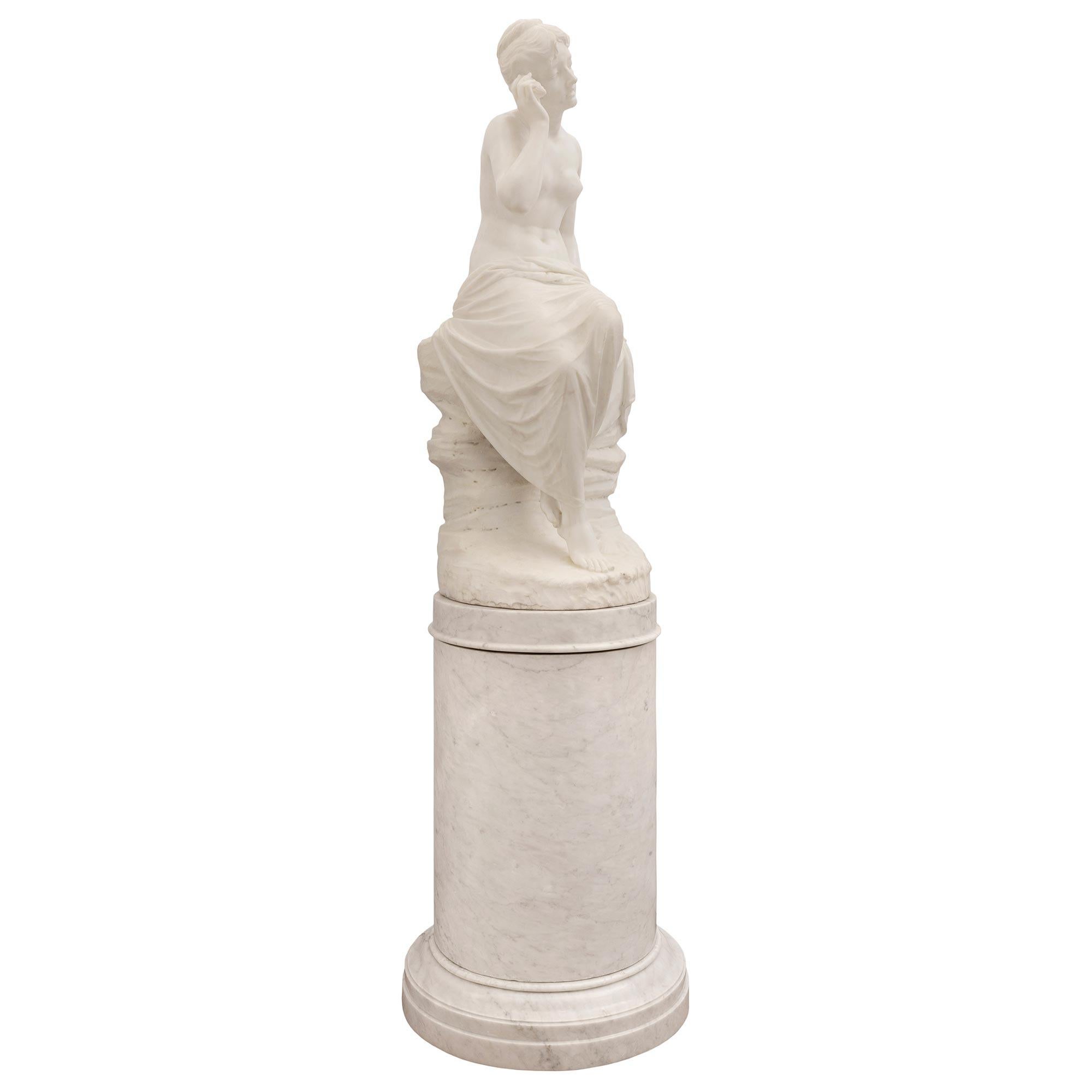A stunning museum quality Italian 19th century white Carrara marble statue of a girl with a seashell on her original pedestal. The statue is raised by its original pedestal column with a fine mottled design at the base and an elegant richly chased