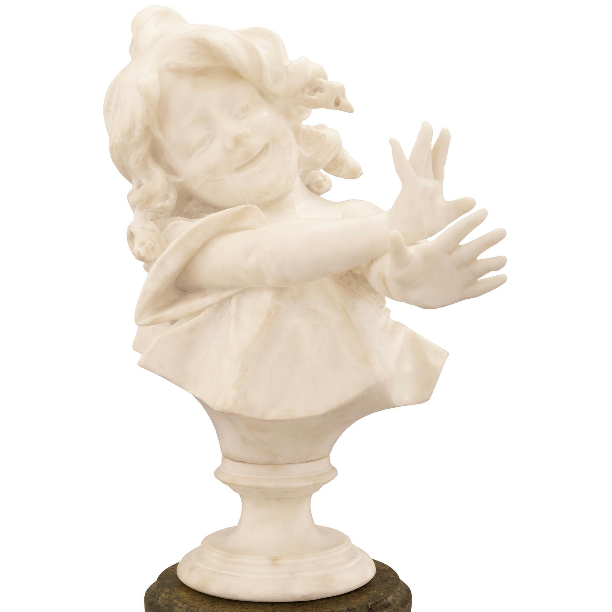 A stunning and most charming Italian 19th century white Carrara marble statue of a young girl on its original Vert de Patricia marble pedestal. The delicately carved statue depicts a young girl smiling with her hands extended in front of her in a