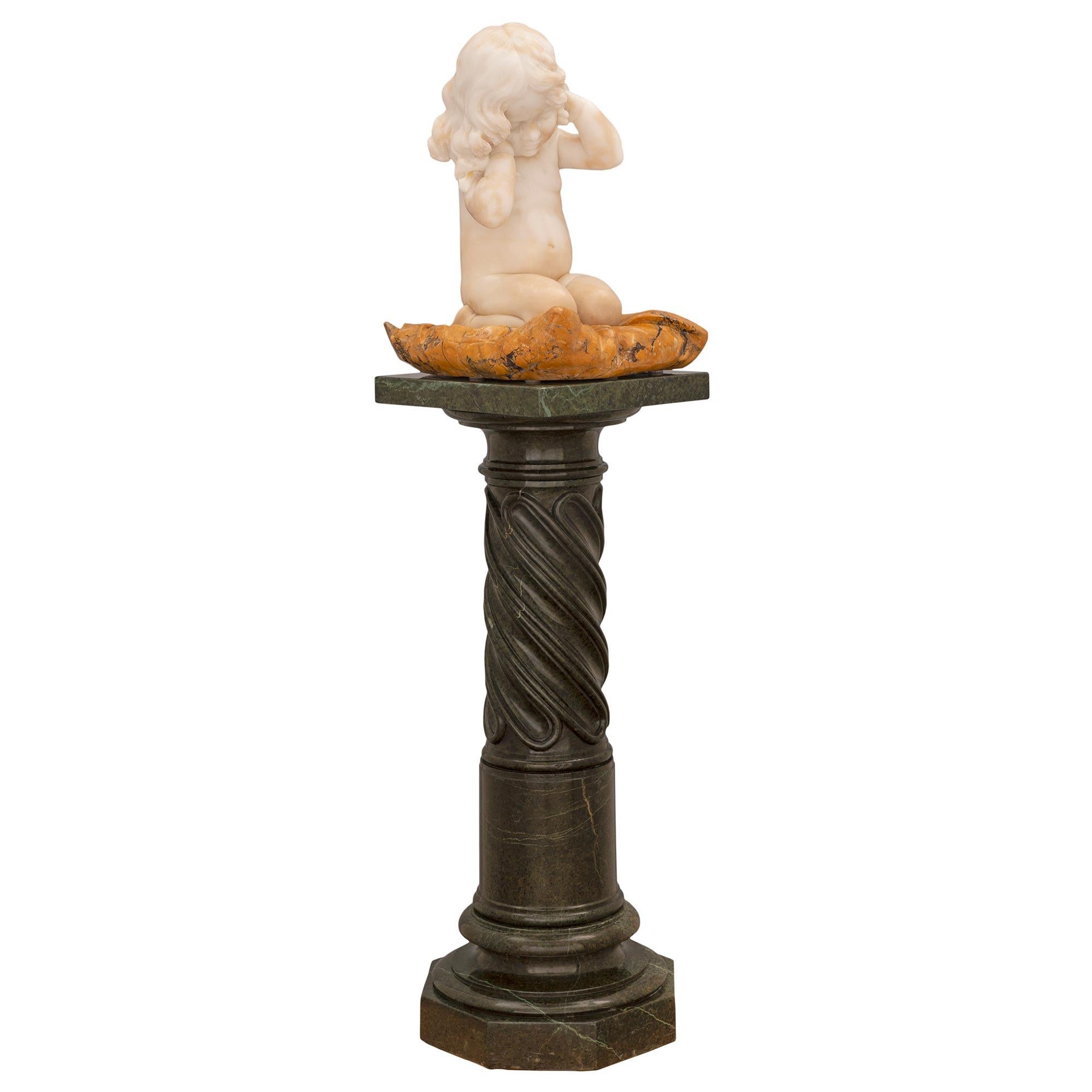 A stunning museum quality Italian 19th century white Carrara, Sienna and Vert de Patricia marble statue on its original pedestal. The pedestal is raised by an elegant octagonal base with a mottled socle shaped support below the most decorative
