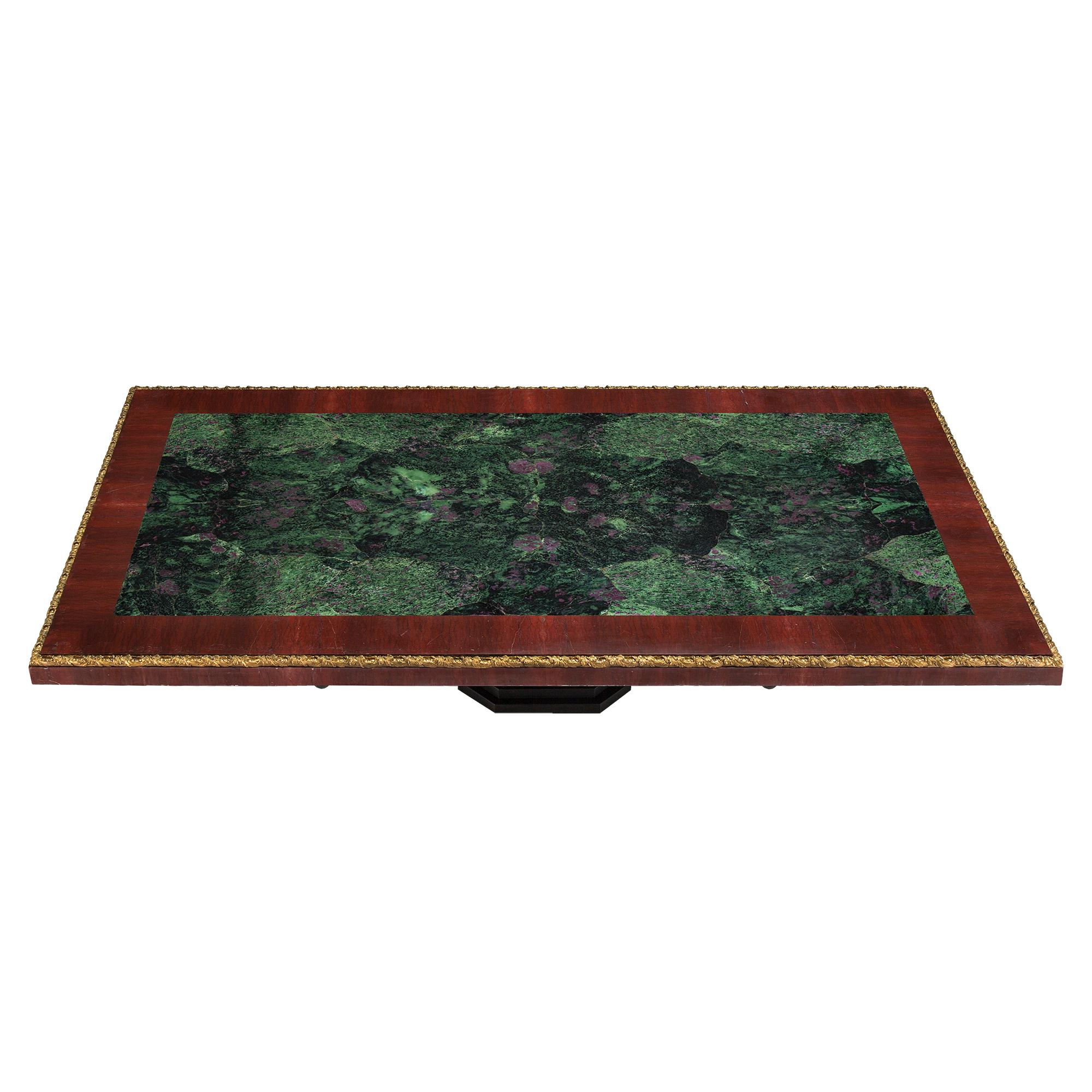 A most impressive Italian 19th century marble, wrought iron and ormolu coffee table. The marble plateau is raised by a stepped black marble base below four most decorative scrolled wrought iron supports. At the center is a handsome scrolled carved