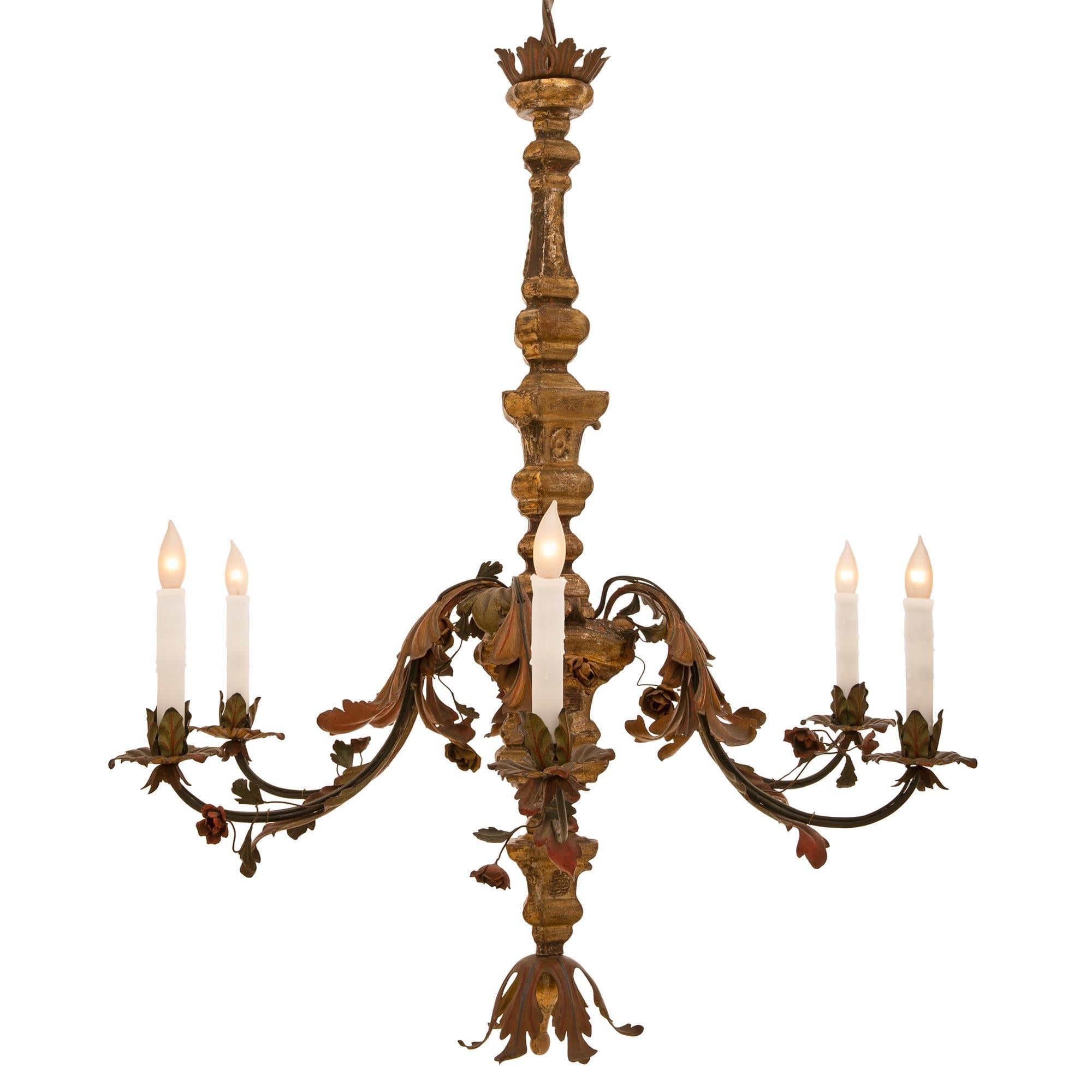 A charming Italian early 19th century mecca and hand painted green and red pressed metal chandelier. The six light chandelier has an unusual triangular shaped fut with an acanthus leaves finial. The fut is centered by six 'S' scrolled metal arms in