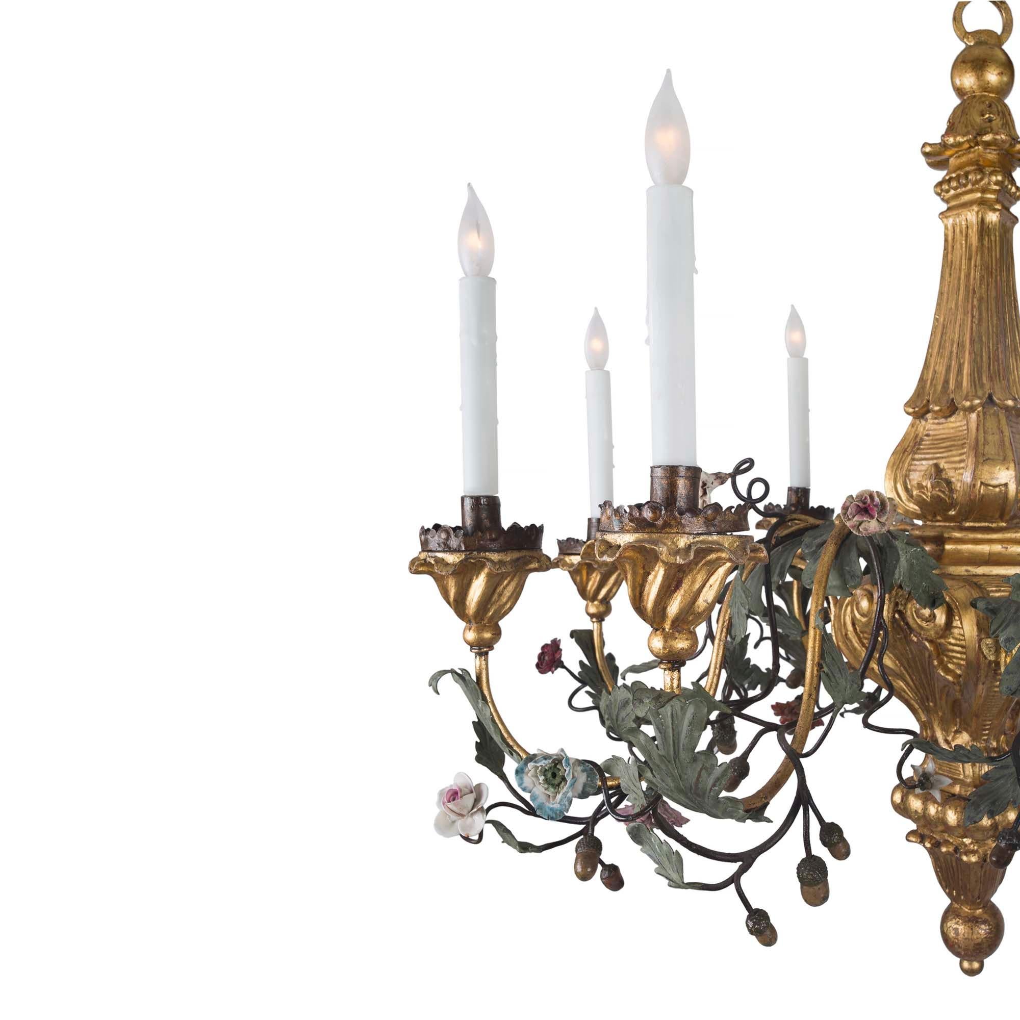 A whimsical and most charming Italian 19th-century giltwood, gilt metal and saxe porcelain eight light chandelier. The chandelier is centered by a fine giltwood ball finial below a foliate and reeded design. Beautiful scrolled movements lead up the