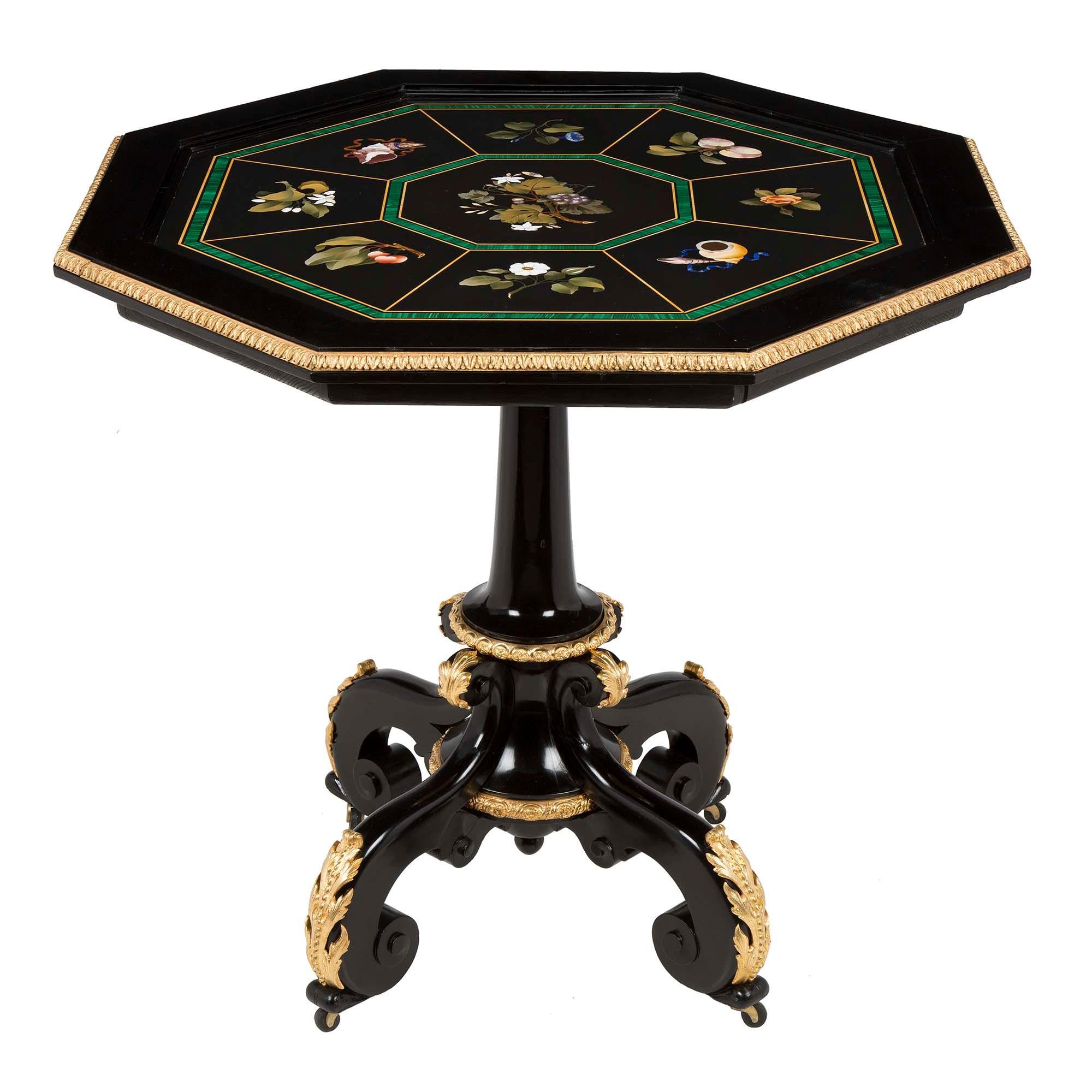 A stunning Italian 19th century Napoleon III Period ebony, marble and ormolu Florentine side table. Raised on scrolled ebony feet with casters, decorated with finely chased acanthus leaf mounts. At the central column support is an inverted finial,