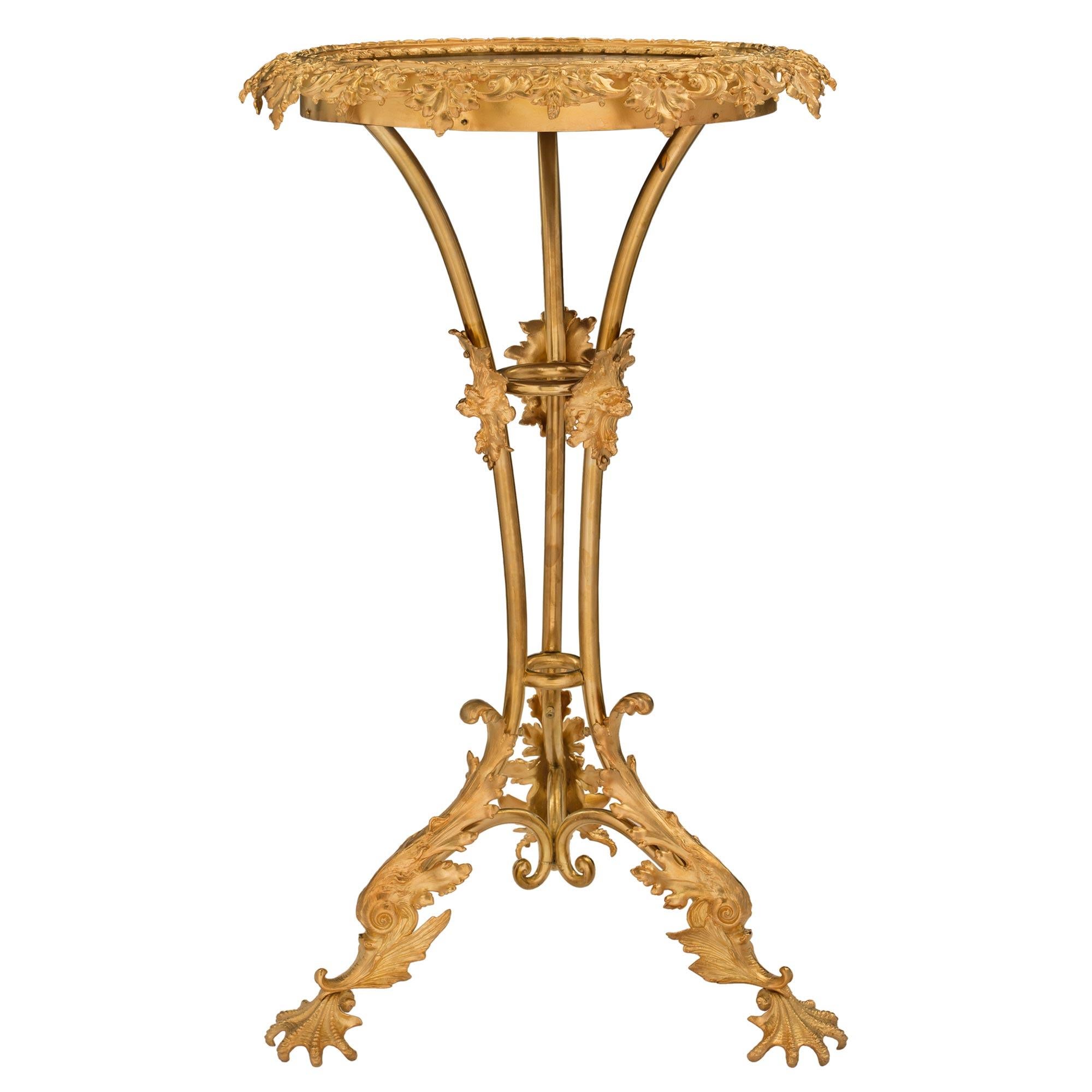 A beautiful Italian 19th century Napoleon III Period ormolu and onyx side table. The table is raised by most unique and extremely decorative foliate feet with beautiful movements and finely chased details. The elegantly curved three central supports