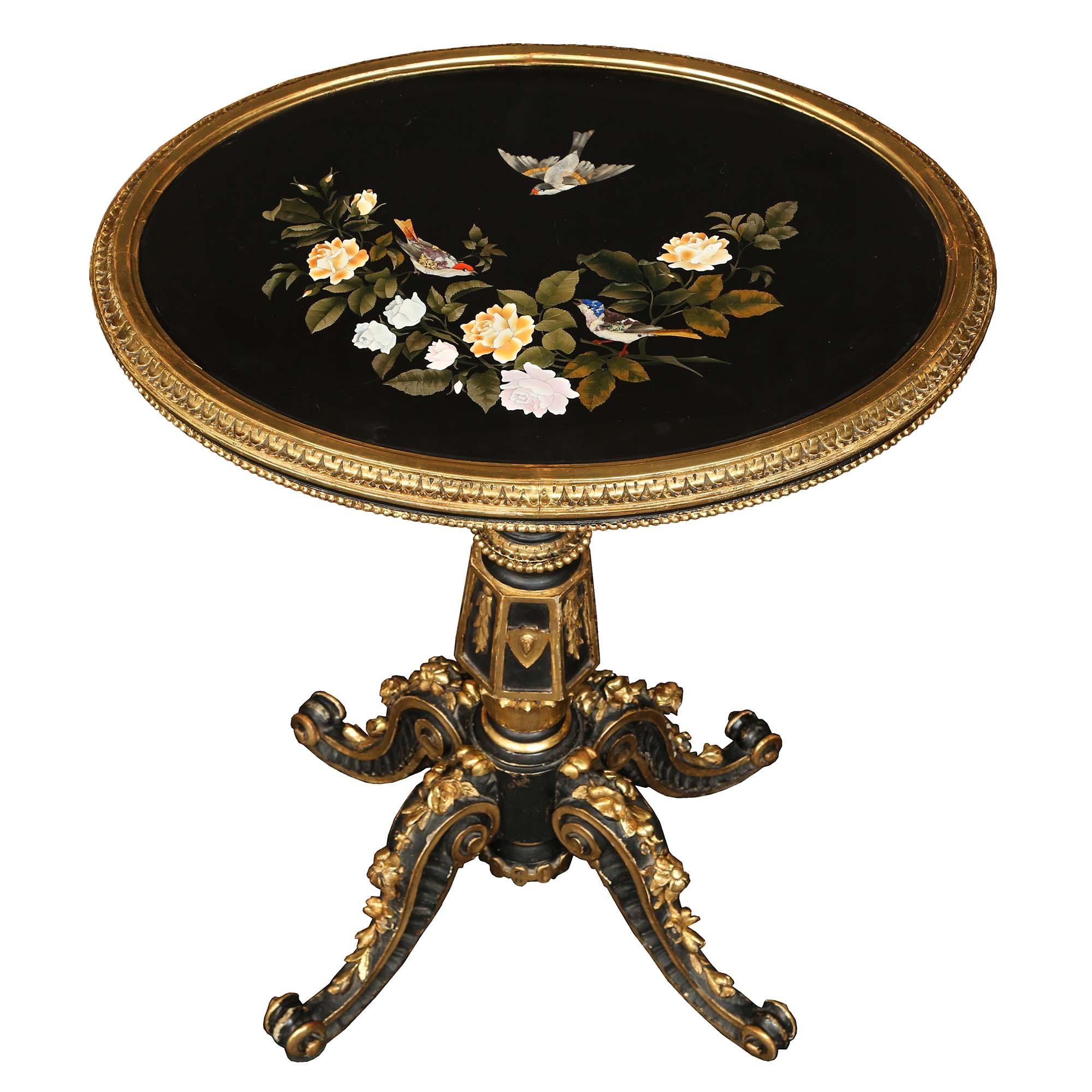 A striking Italian 19th century Napoleon III Period patinated black, giltwood and Pietra Dura marble Florentine oval side table. The table is raised by four elegant S scrolled black patinated legs decorated with wonderful reeded patterns, giltwood