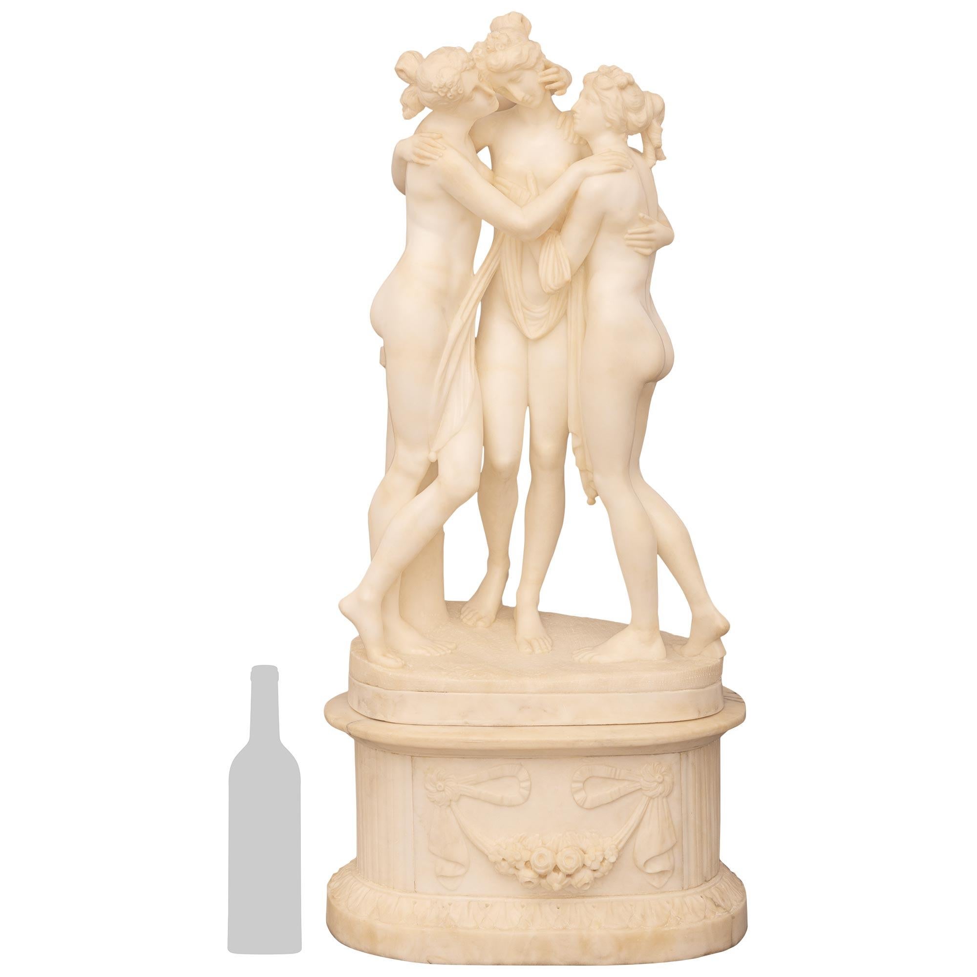 A beautiful Italian 19th century Neo-Classical st. Alabaster statue of The Three Graces. This wonderful Alabaster statue is raised by its original oval base with mottled edges and decorated with swaging floral garlands held by flowing fabrics. The