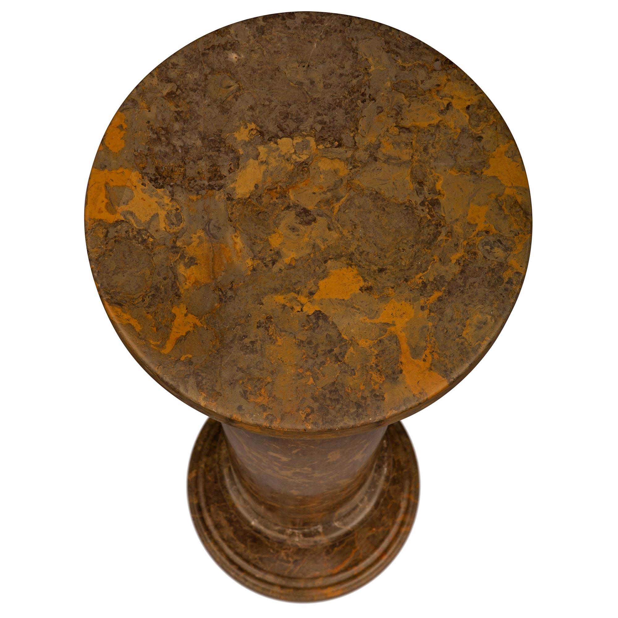 A striking Italian 19th century Neo-Classical st. faux painted composite stone pedestal column. The column is raised by a circular base with a fine double mottled border and elegantly curved design. The circular central support displays a