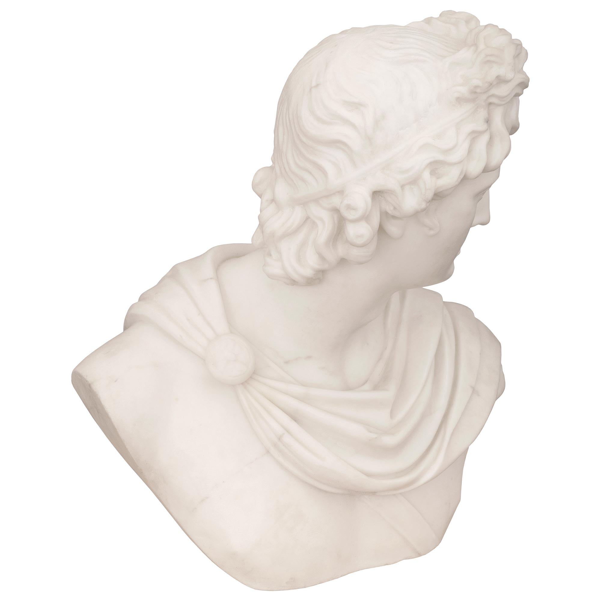 An exceptional Italian 19th century neoclassical st. white Carrara marble bust of Apollo Belvedere signed A. Frilli Florence. The wonderfully executed bust depicts the handsome Apollo draped in a flowing paludamentum fastened by a fibula with a band