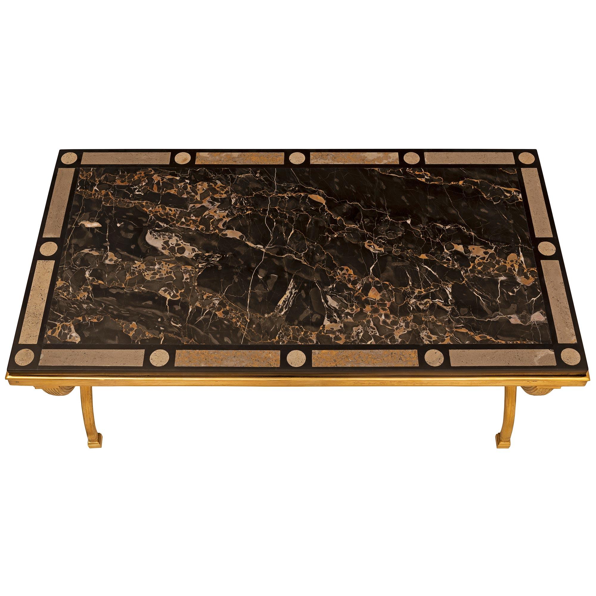 A stunning Italian 19th century Neo-Classical st. ormolu Portoro, black Belgian marble and soapstone specimen marble coffee table. The rectangular table is raised by beautiful elegantly curved fluted legs with block feet and connected by a turned