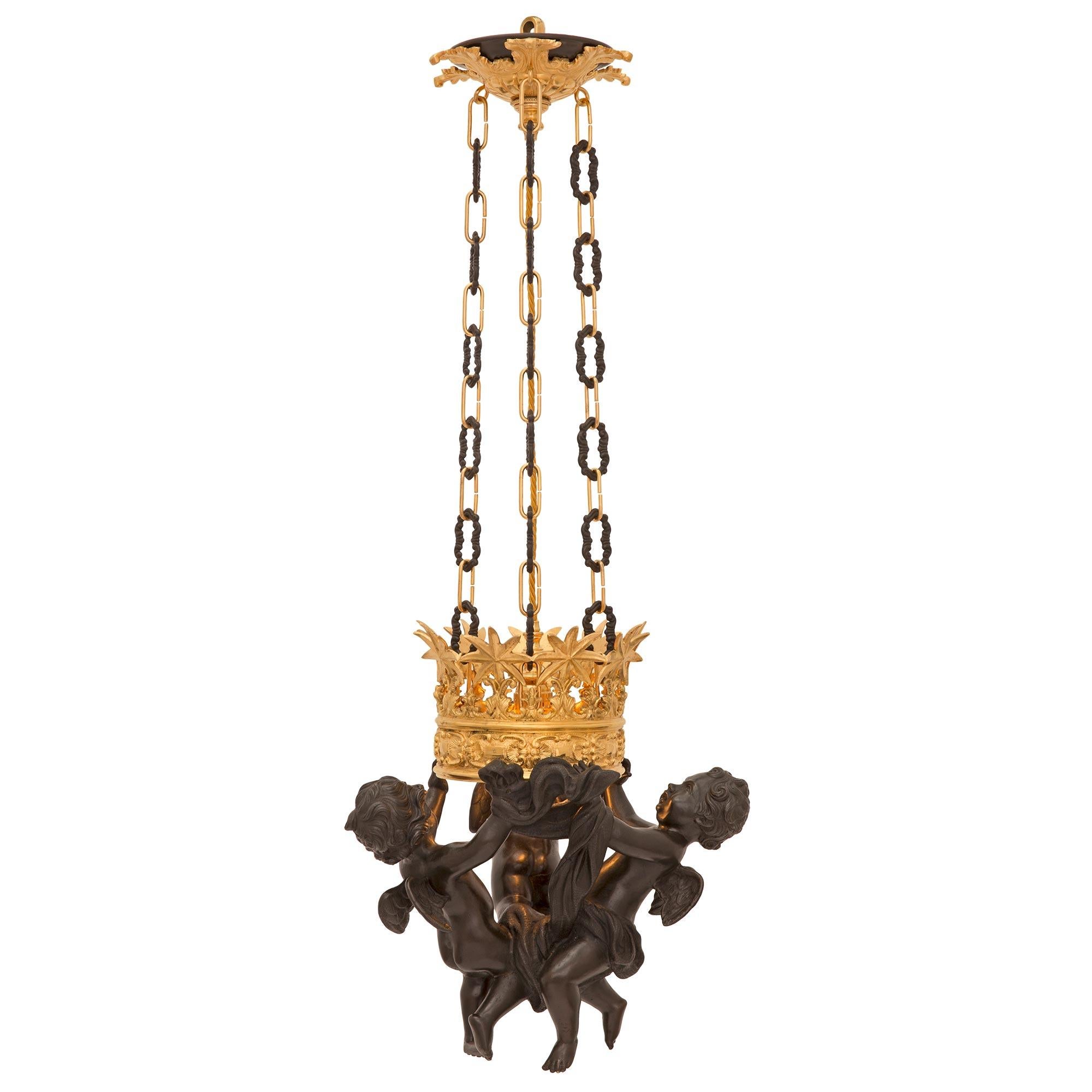 A most unique and high quality Italian 19th century Neo-Classical st. patinated bronze and ormolu lantern. The lantern displays three charming and wonderfully executed winged cherubs each holding hands and supporting the most impressive central