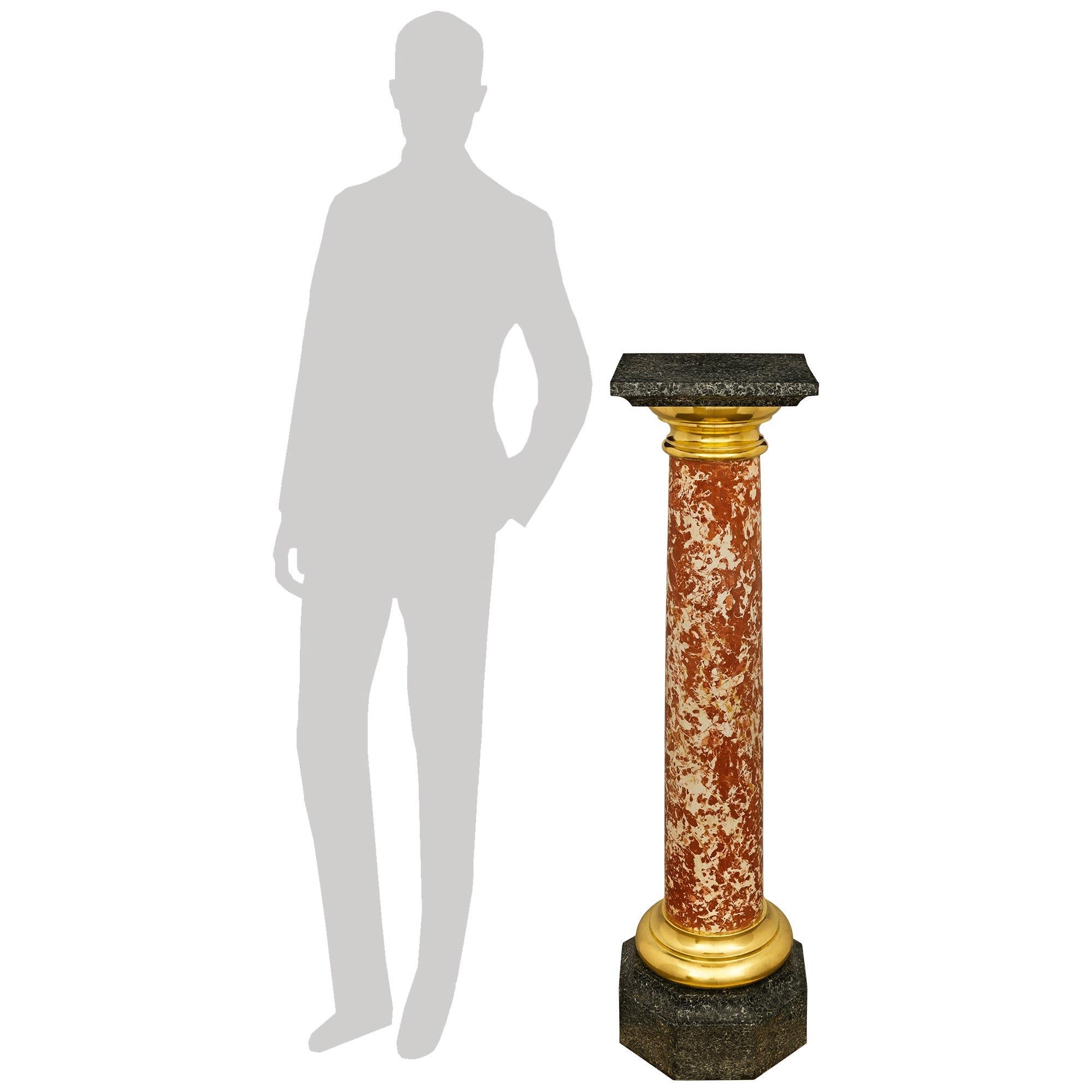 A handsome Italian 19th century Neo-Classical st. Scagliola and Ormolu pedestal. This wonderfully detailed dark faux painted marble column is raised on an octagonal base displaying a concave top border below a mottled circular Ormolu band. Above is