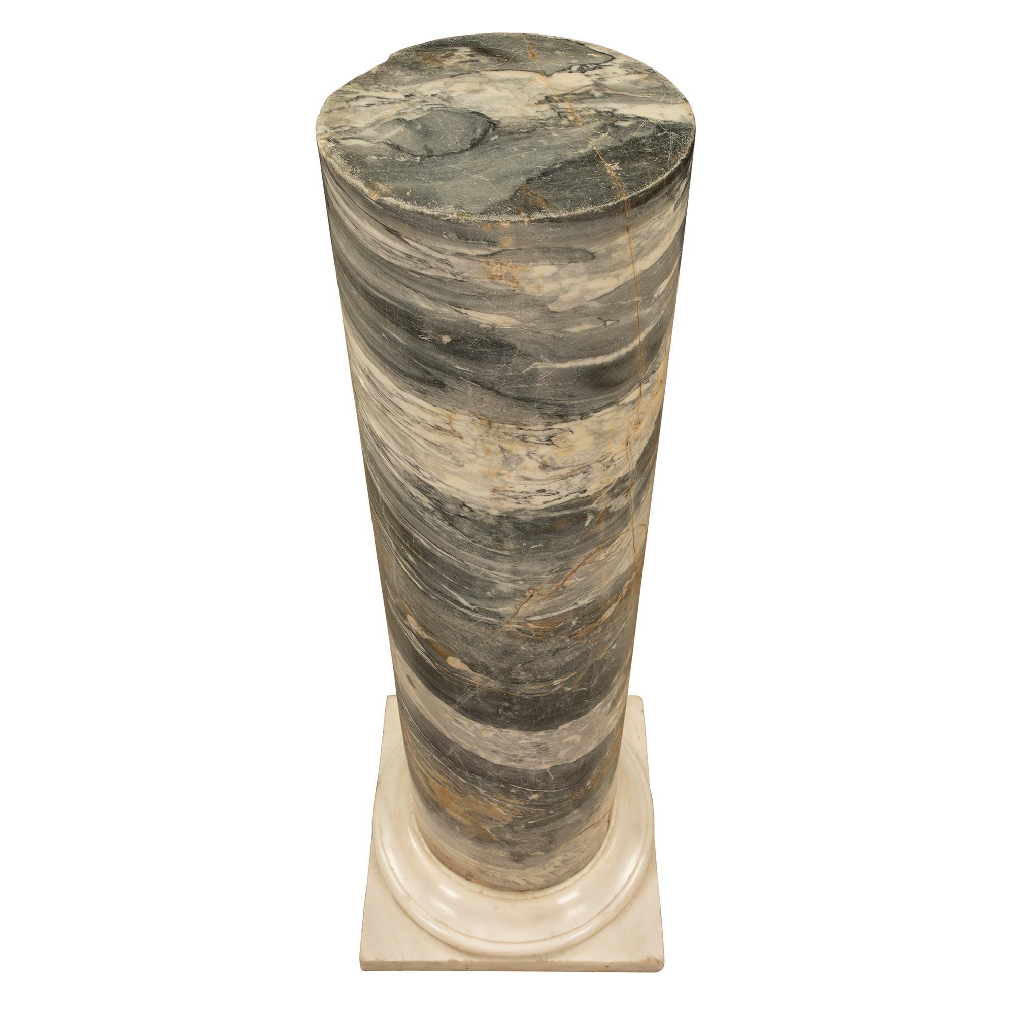 A striking Italian 19th century Neo-Classical st. solid marble column. The column is raised by a square white Carrara marble base with a fine and most decorative mottled design. The circular central column showcases a beautiful and most unique