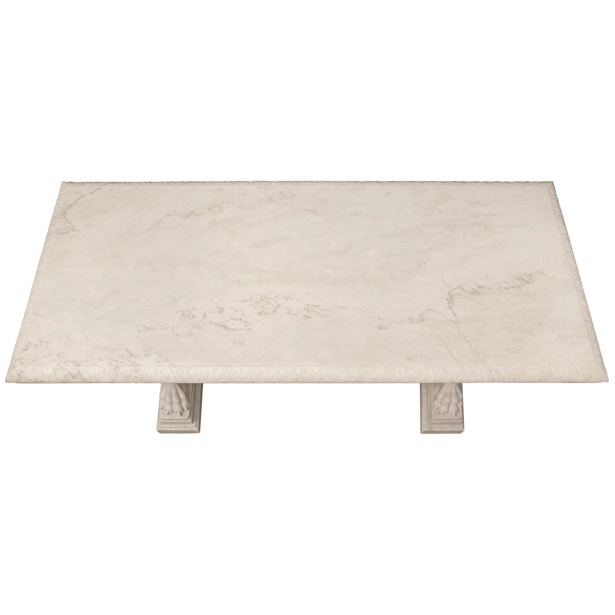 A spectacular and most impressive Italian 19th century neo-classical st. white Carrara marble center table. The monumentally scaled rectangular table is raised by stunning intricately detailed supports each displaying a fine mottled stepped base