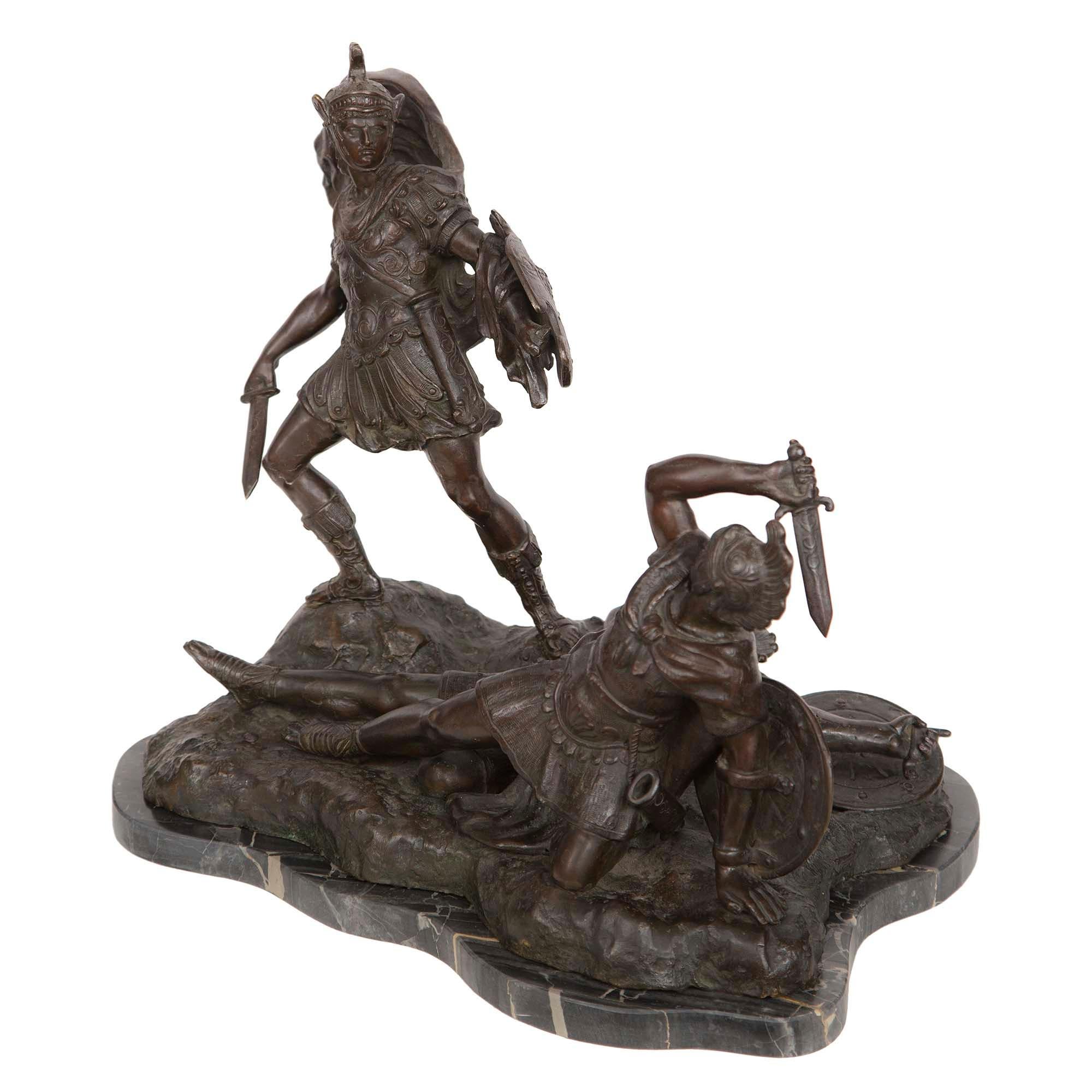 A handsome Italian 19th century neoclassical patinated bronze and Portoro marble statue of soldiers fighting signed. The statue is raised by a scalloped shaped Portoro marble base mimicking the shape of the bronze above. Set on a ground like design