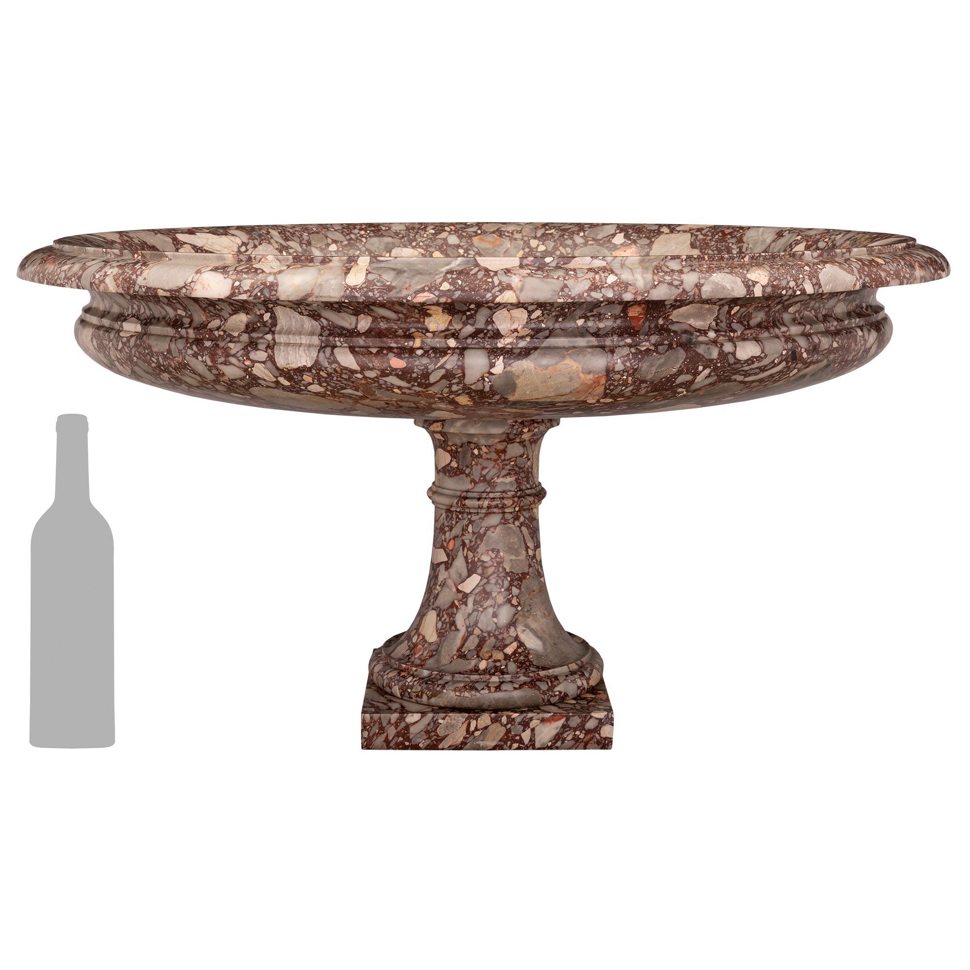 A stunning and most impressive Italian 19th century Neo-Classical st. Breccia de Bourgogne marble bird bath/urn. The striking urn is raised by a square base below the socle shape pedestal with an elegant wrap around mottled band. The beautiful large