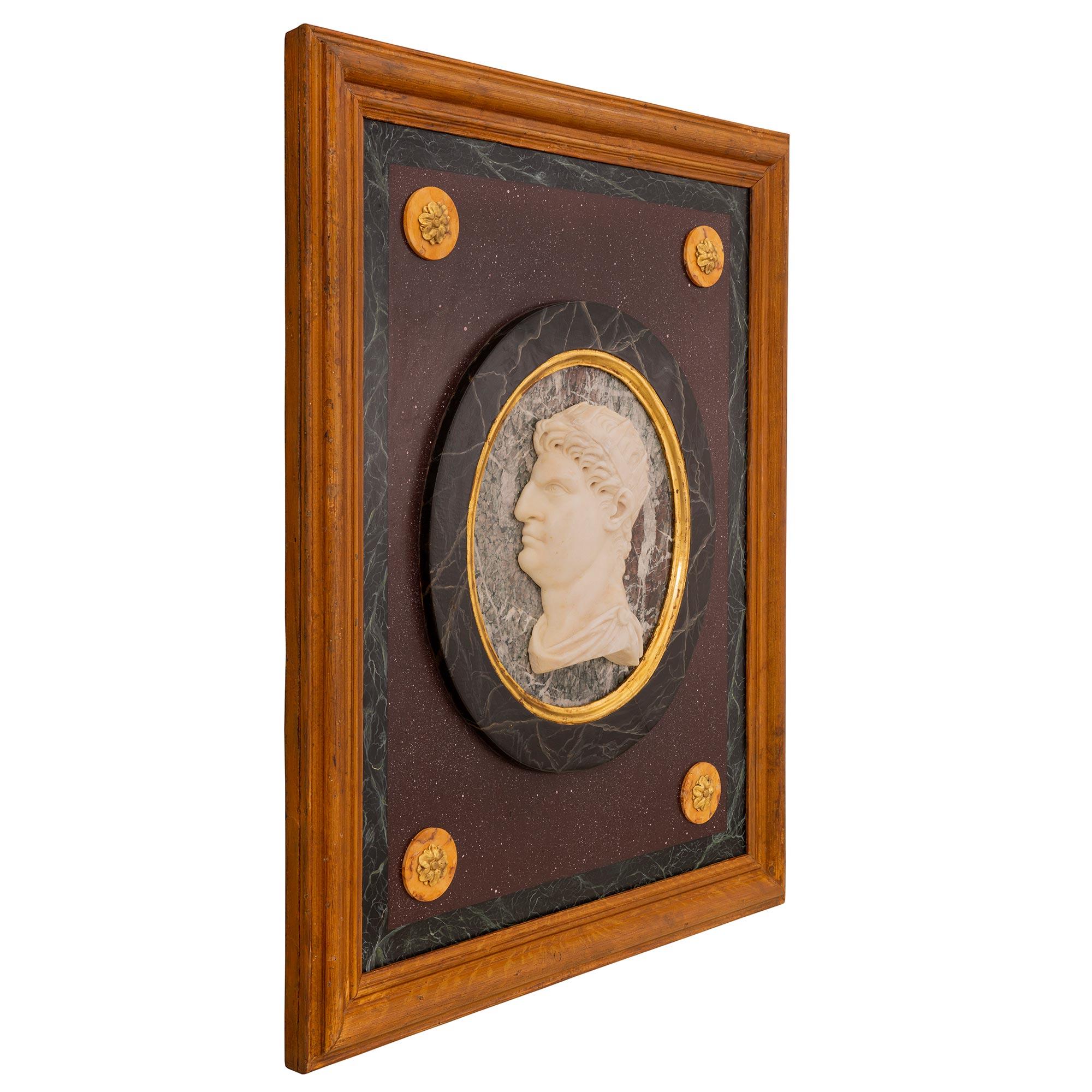 A powerful and high quality Italian 19th century neo-classical st. giltwood, white Carrara marble, faux painted marble and patinated wood decorative wall plaque of a Roman Emperor. The plaque in centered by a wonderfully carved central white Carrara