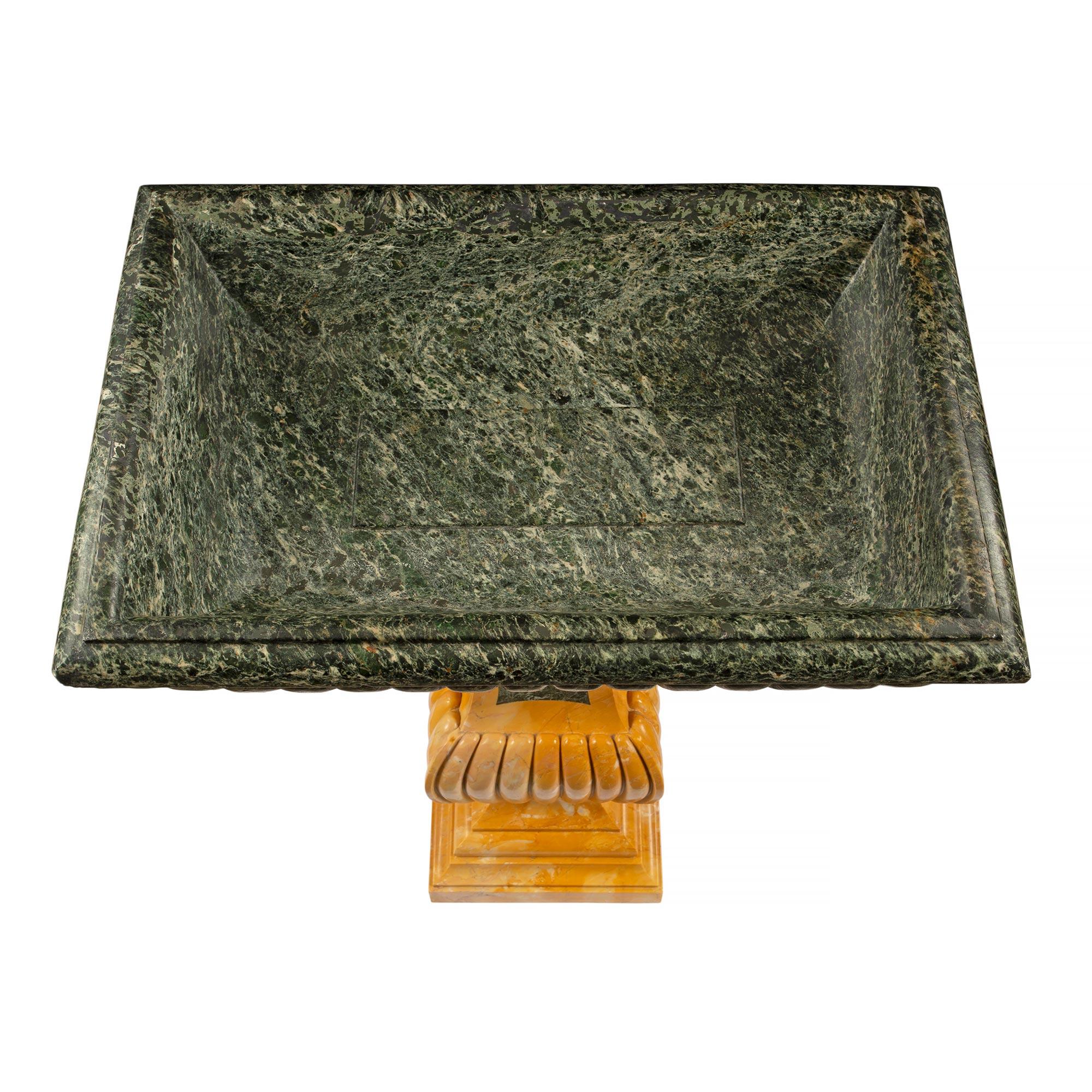 A handsome and very decorative Italian 19th century neo-classical st. Sienna and Vert Antique marble birdbath/planter. The planter is raised by a mottled rectangular base below a tapered fut and a gadroon shaped mid section. Above is the extended
