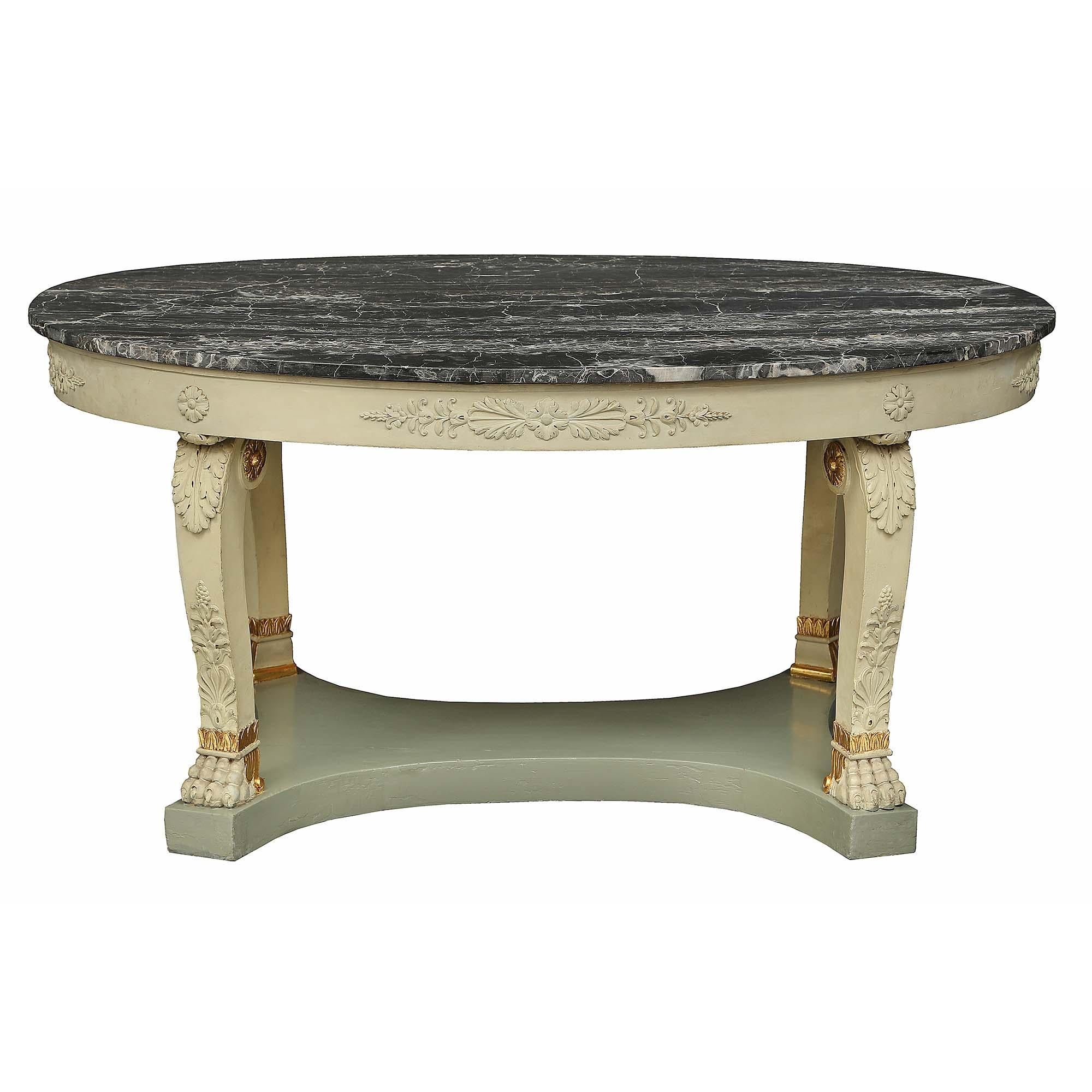 A wonderful and decorative Italian 19th century neo-classical st. patinated and marble oval center table. The table is raised by a bottom tier with concave sides and four square scrolled legs with handsome paw feet. The supports are decorated with