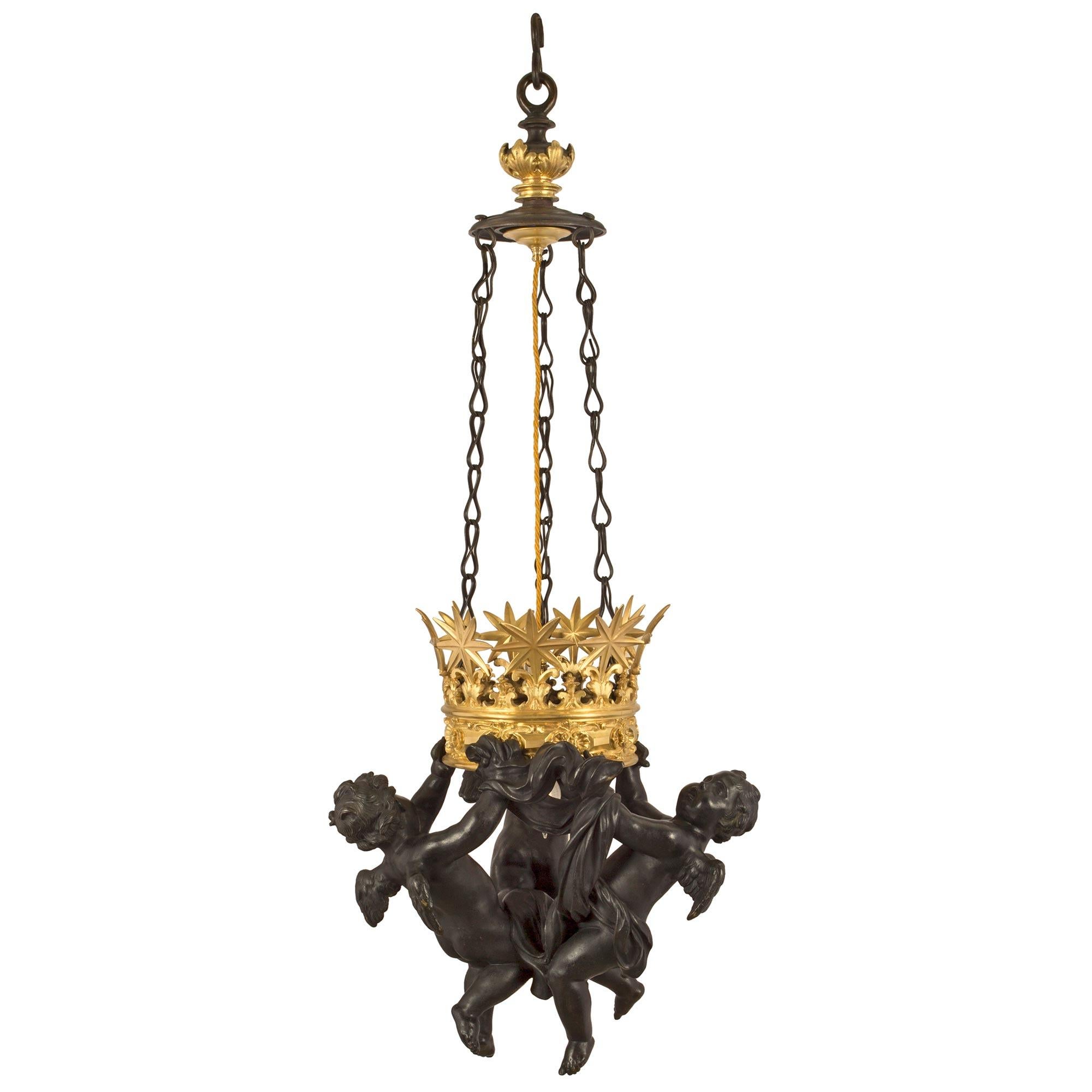 A most unique and high quality Italian 19th century Neo-Classical st. patinated bronze and ormolu hanging lantern. The lantern has three charming and expressive winged cherubs with rich and warm patina. The cherubs are holding to a fanciful and most