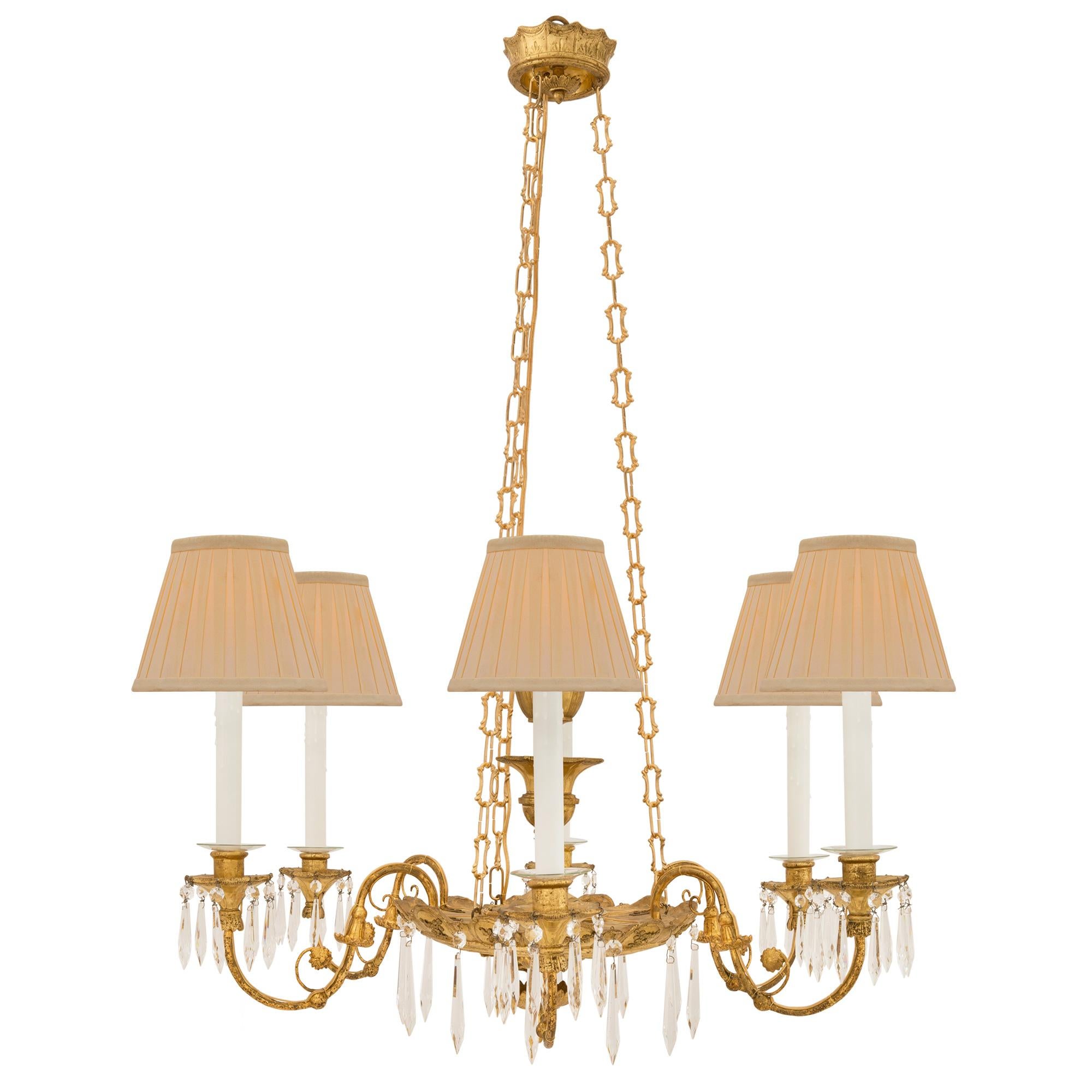 A beautiful Italian 19th century neo-classical st. giltwood and ormolu chandelier. The six arm chandelier is centered by a lovely bottom finial amidst finely carved foliate designs and intricately detailed palmettes. Each elegantly scrolled arm is