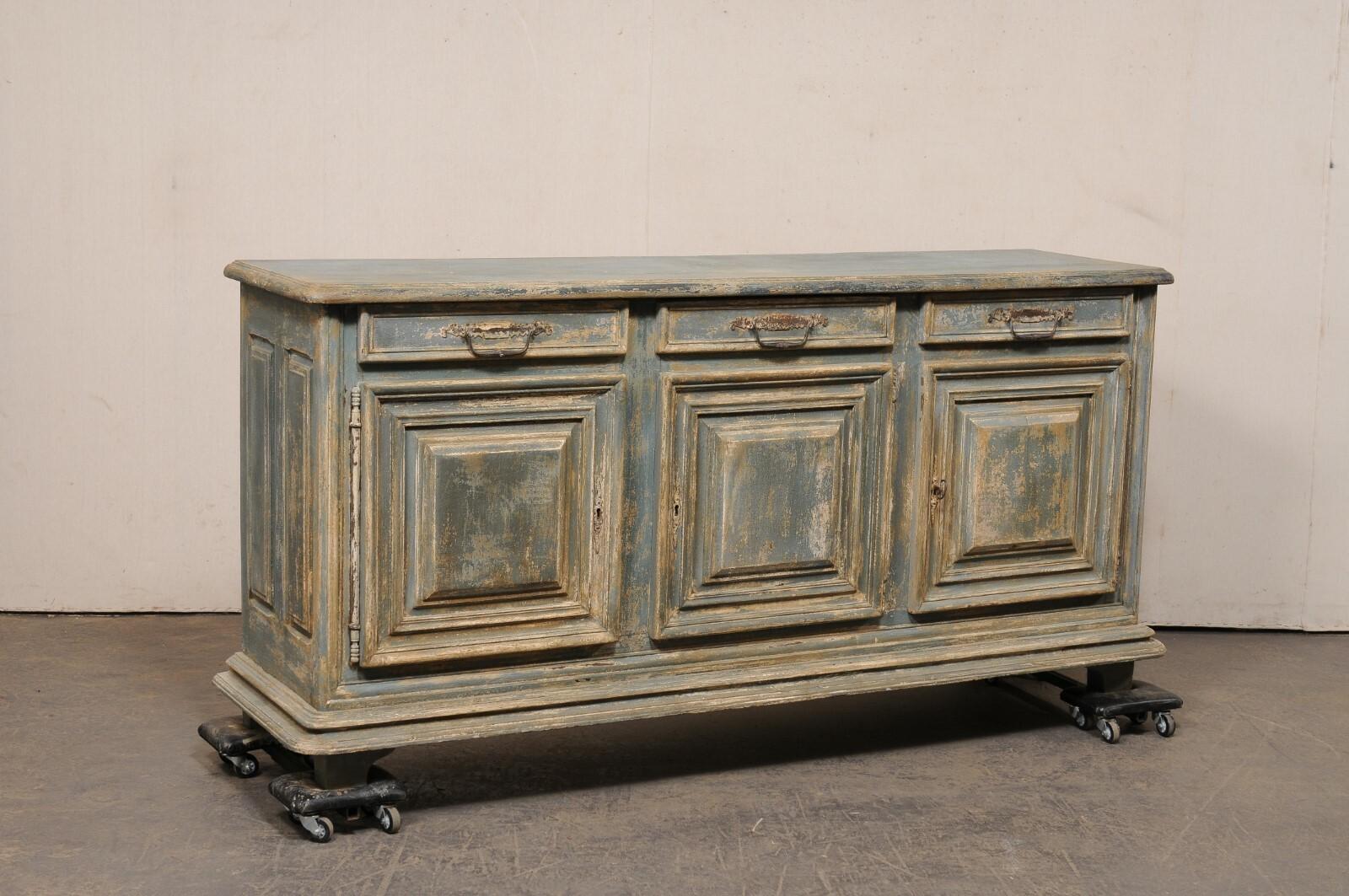 An Italian carved and painted wood buffet console from the 19th century. This antique chest from Italy has a rectangular-shaped top with beveled edges and softly rounded front corners, upon a case which houses three drawers set in horizontal fashion