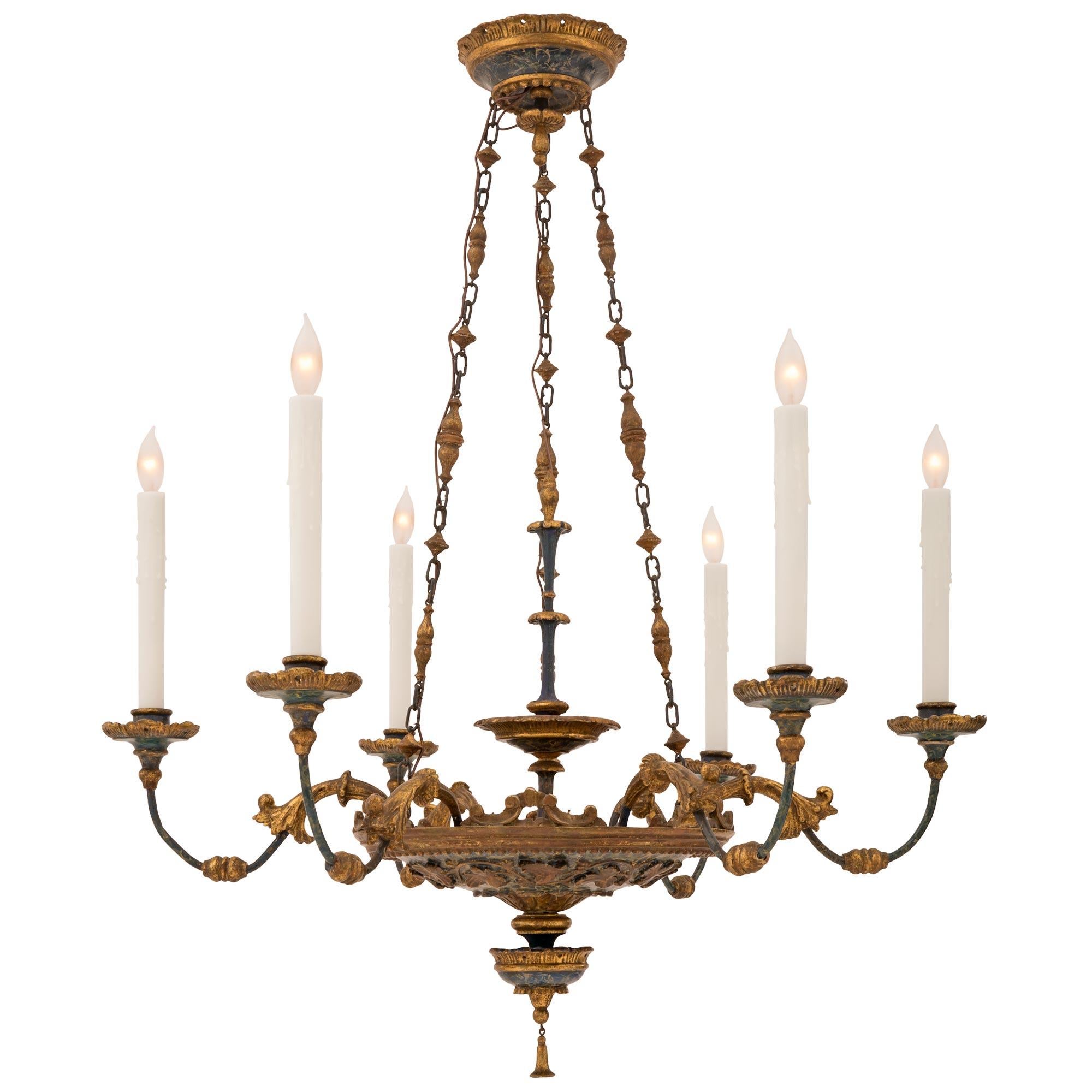 A lovely Italian 19th century Louis XVI st. giltwood and faux painted marble chandelier. The six arm chandelier is centered by a charming bottom bell shaped giltwood pendant below the striking warm blue colored faux painted marble body with a