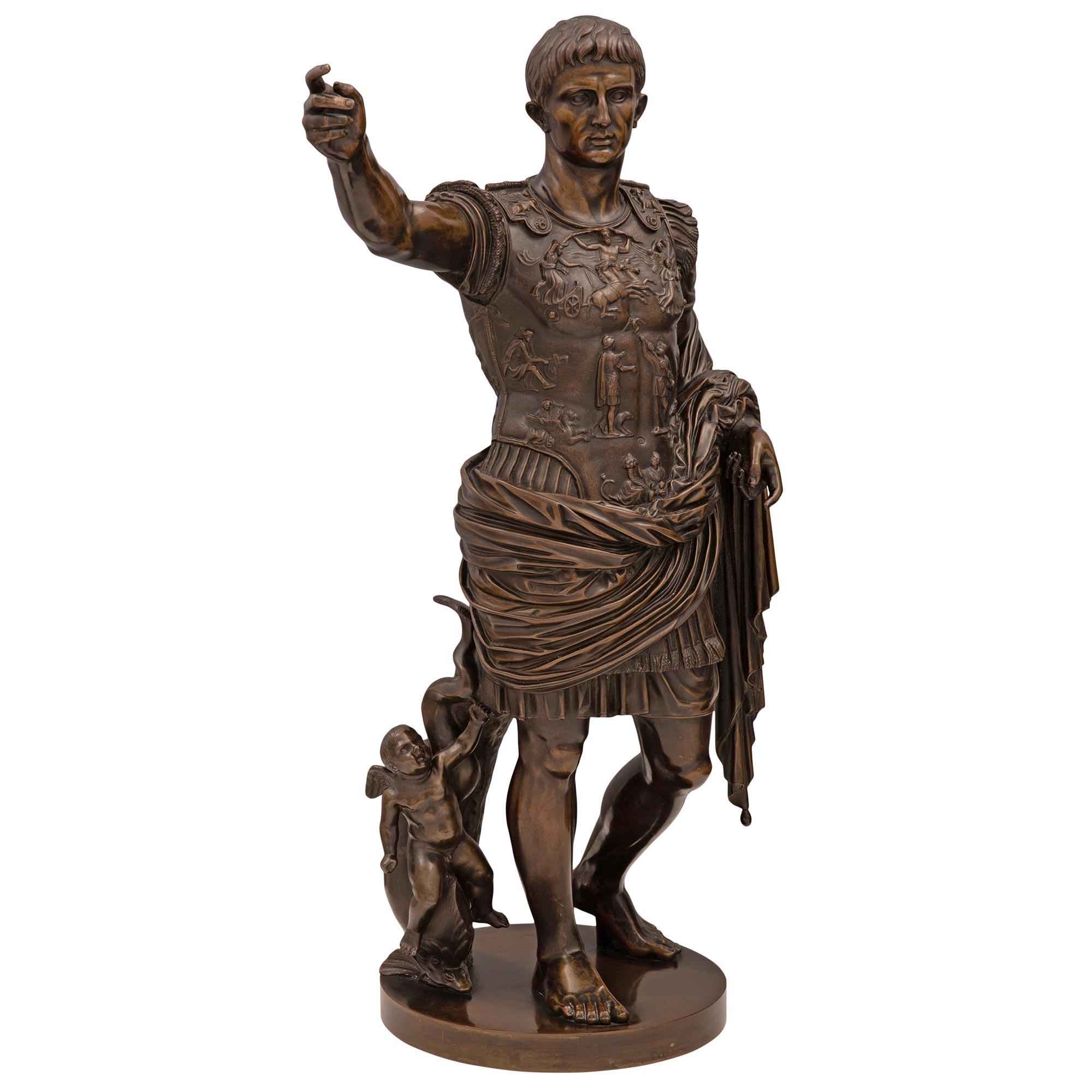 A handsome and high quality Italian 19th century patinated bronze statue of Augustus of Prima Porta. The statue is raised by a circular base where the emperor stands proudly with his right arm raised. He is draped in a wonderfully executed flowing