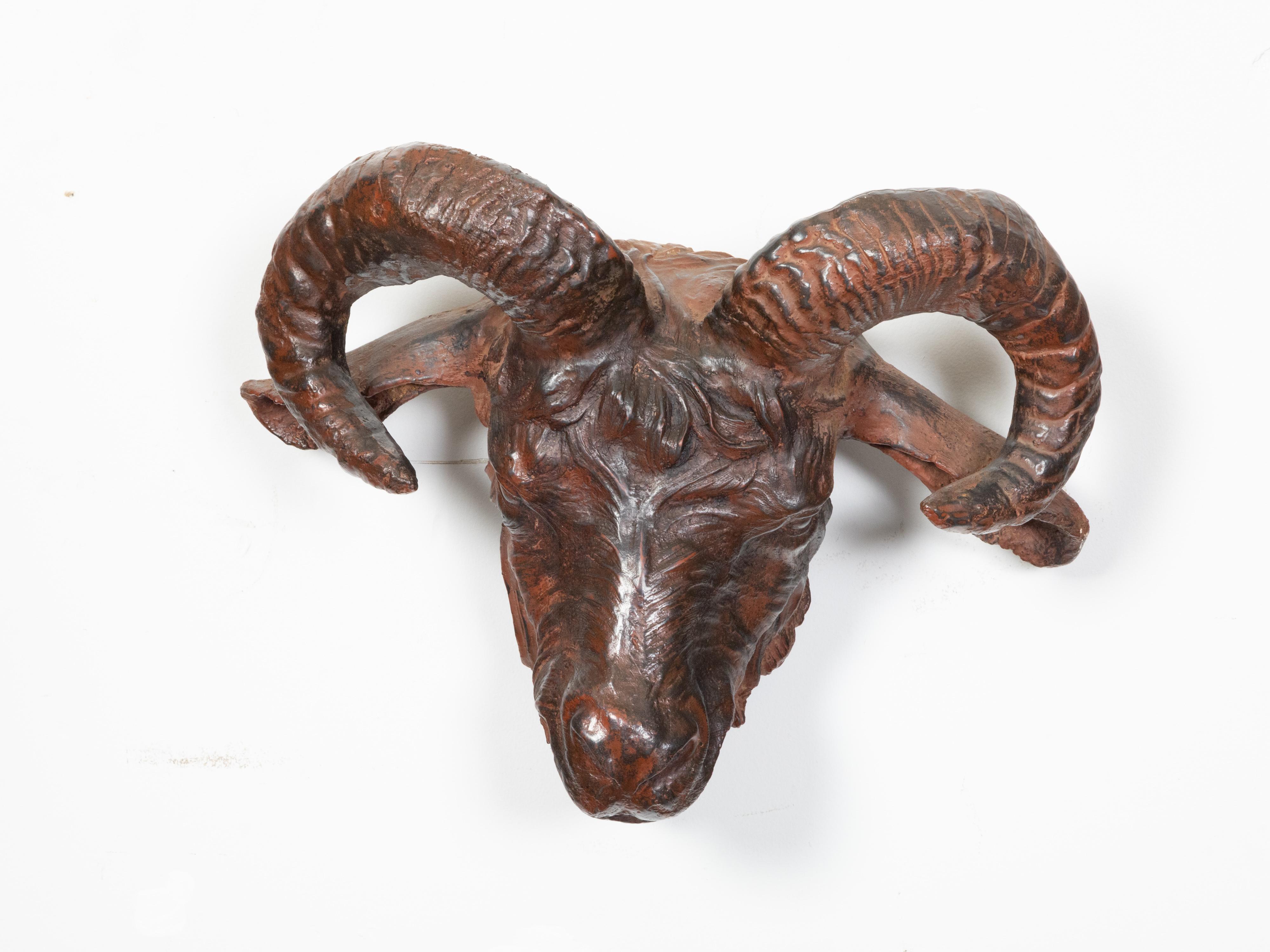 An Italian wall hanging patinated iron ram's head sculpture from the 19th century, with rusty finish and great finesse in the details. Created in Italy during the 19th century, this iron ram's head is a showstopper! Showcasing a nice rusty patina,