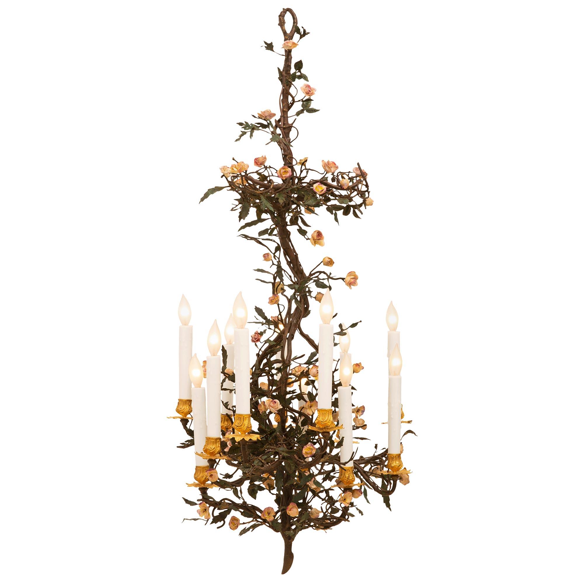 A lovely and unique Italian 19th-century porcelain and ormolu chandelier, from Turin. The twelve light chandelier displays impressive and extremely decorative metal branch-like movements throughout, and elegant hand-painted porcelain flowers. At the