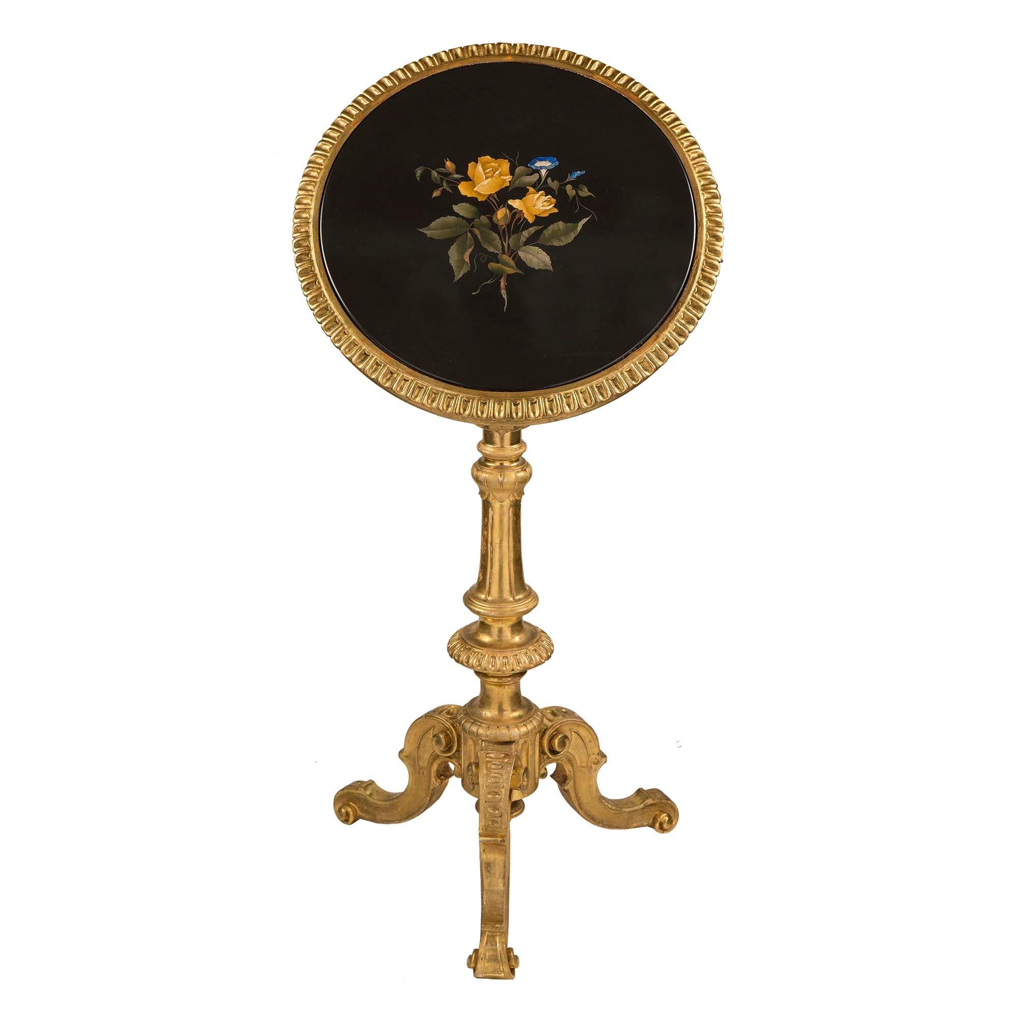 A stunning Italian 19th century rare and unusual tilt top Florentine side table. The table is raised on scrolled tripod with fluted and carved central column. At the circular giltwood, frieze are scalloped designs and fluted top band. All below the