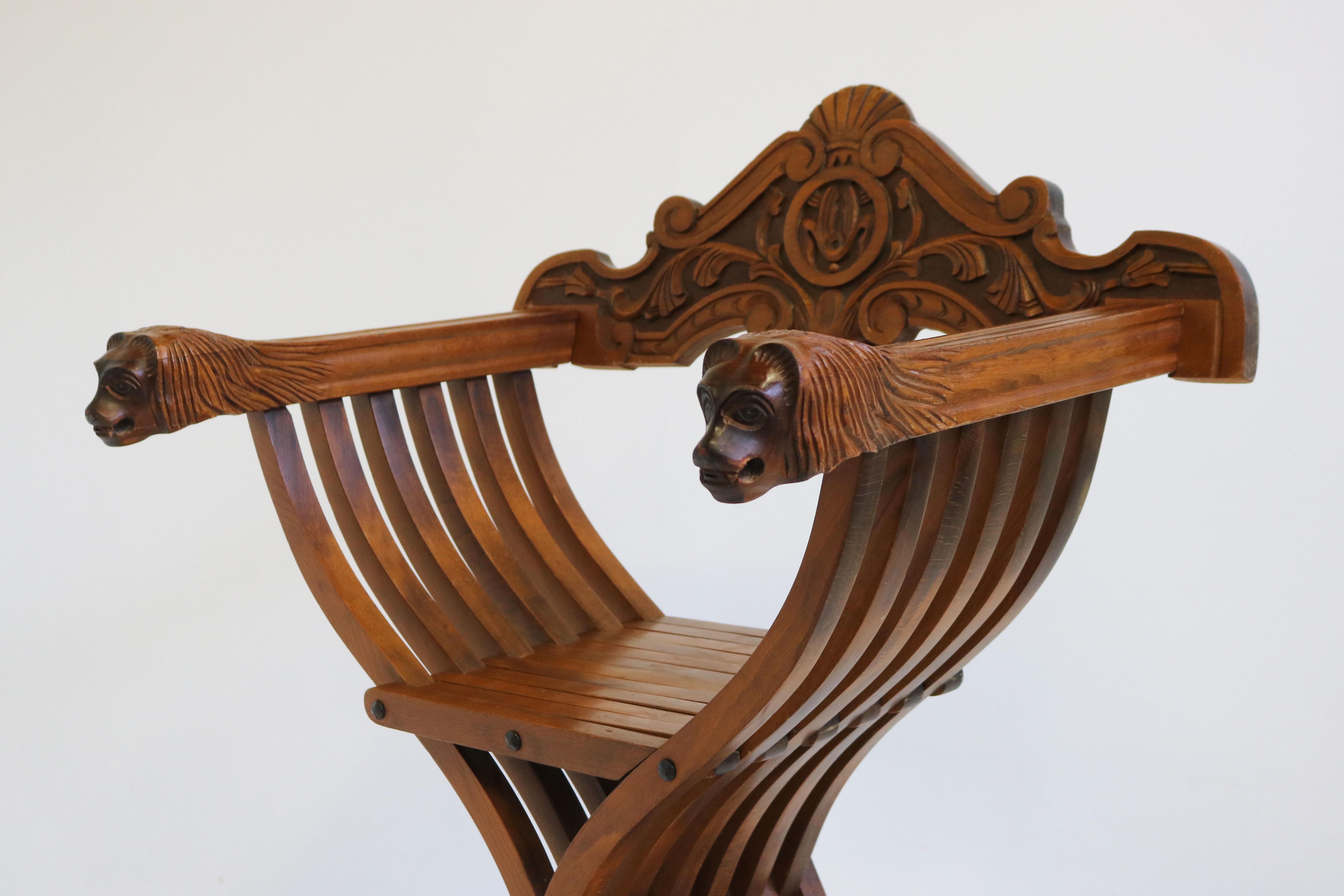 Impressive & fully original Florentine Renaissance Savonarola chair in carved walnut. Restored in our workshop and it looks simply stunning. 
Armrests ending with two amazing hand-carved lion heads. The lion heads where used to display the